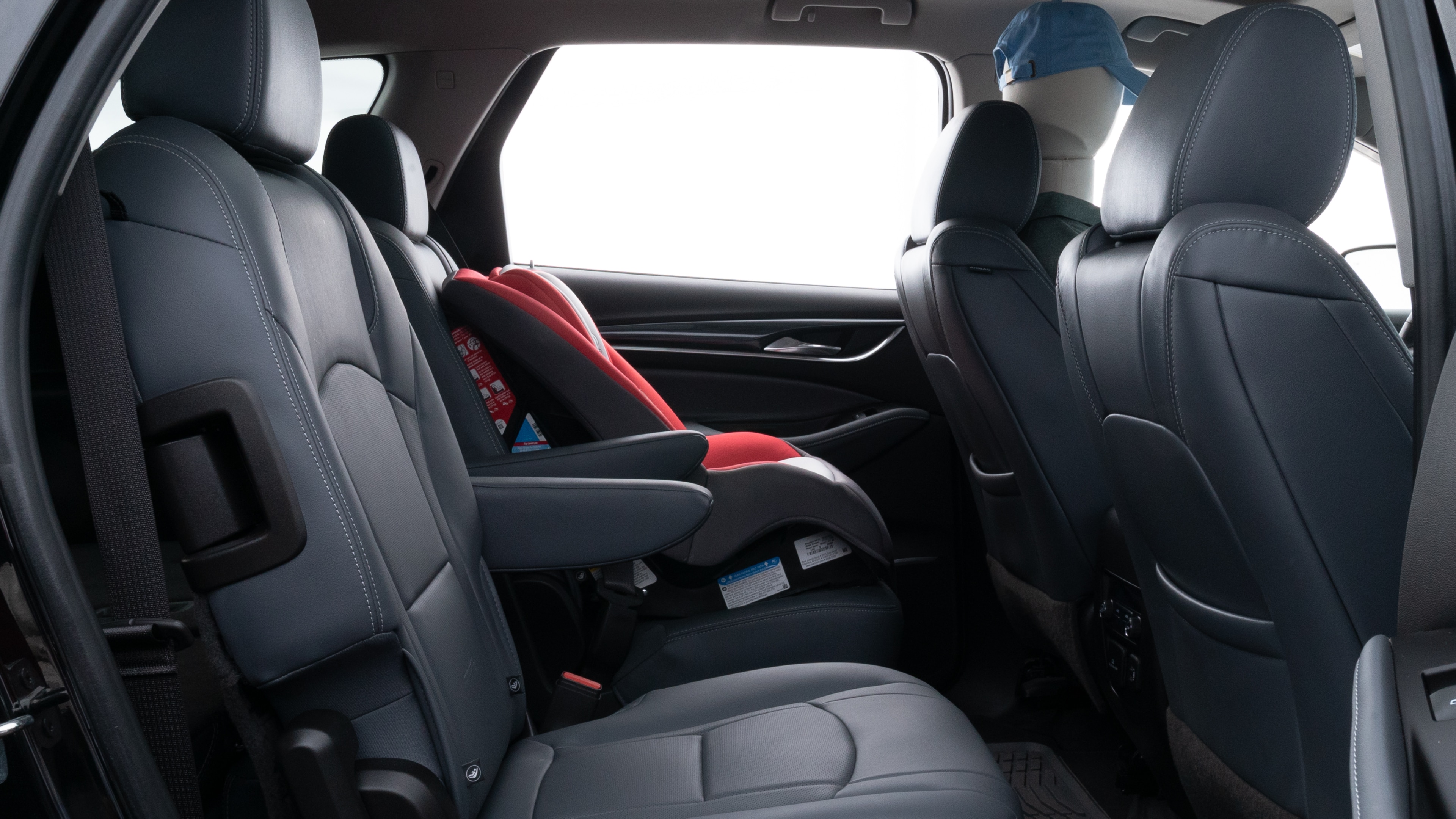 A series of second-row backseat photos is shown including one seating a baby seat and one seating a 6'1" mannequin.