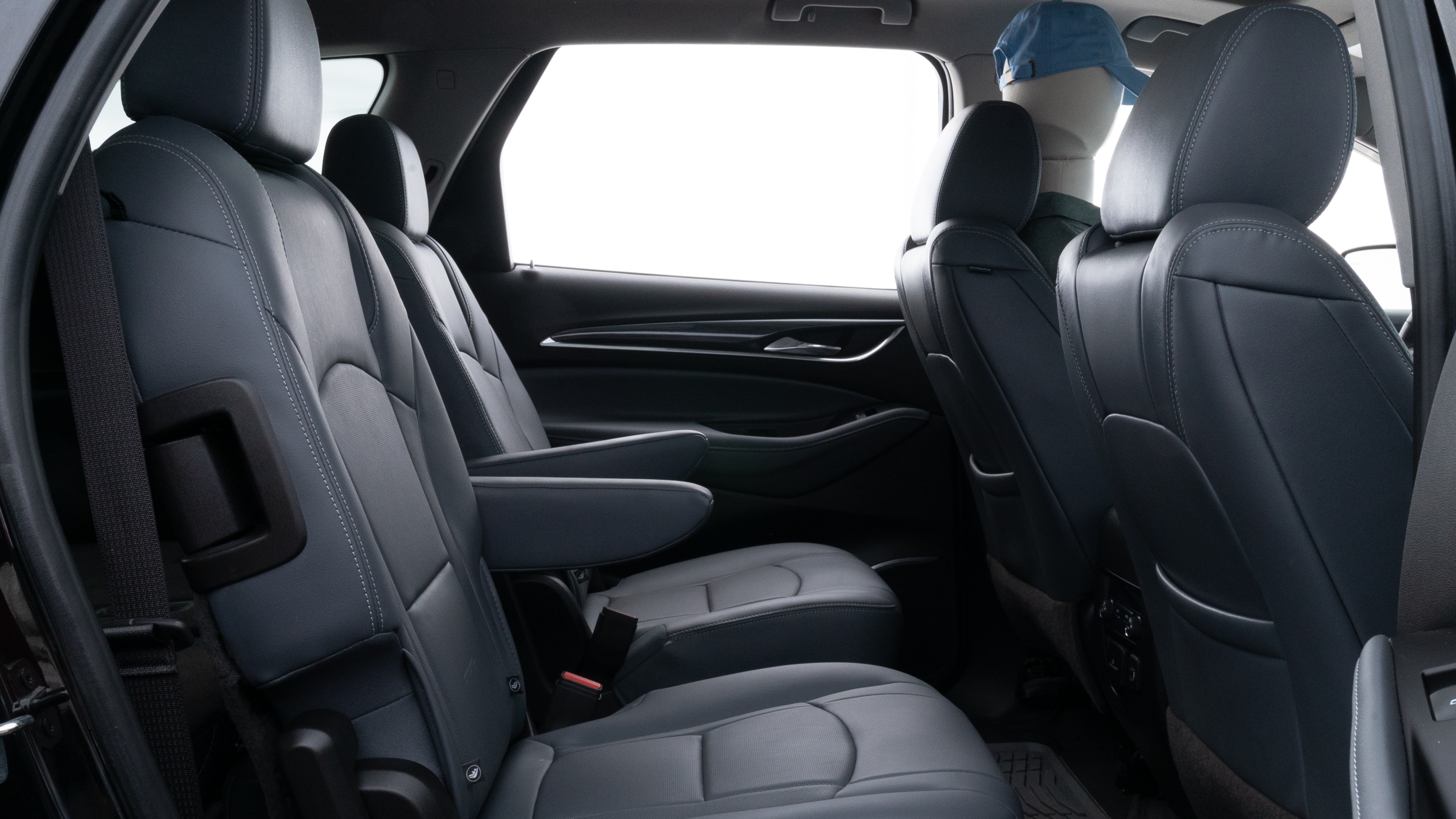 A series of second-row backseat photos is shown including one seating a baby seat and one seating a 6'1" mannequin.