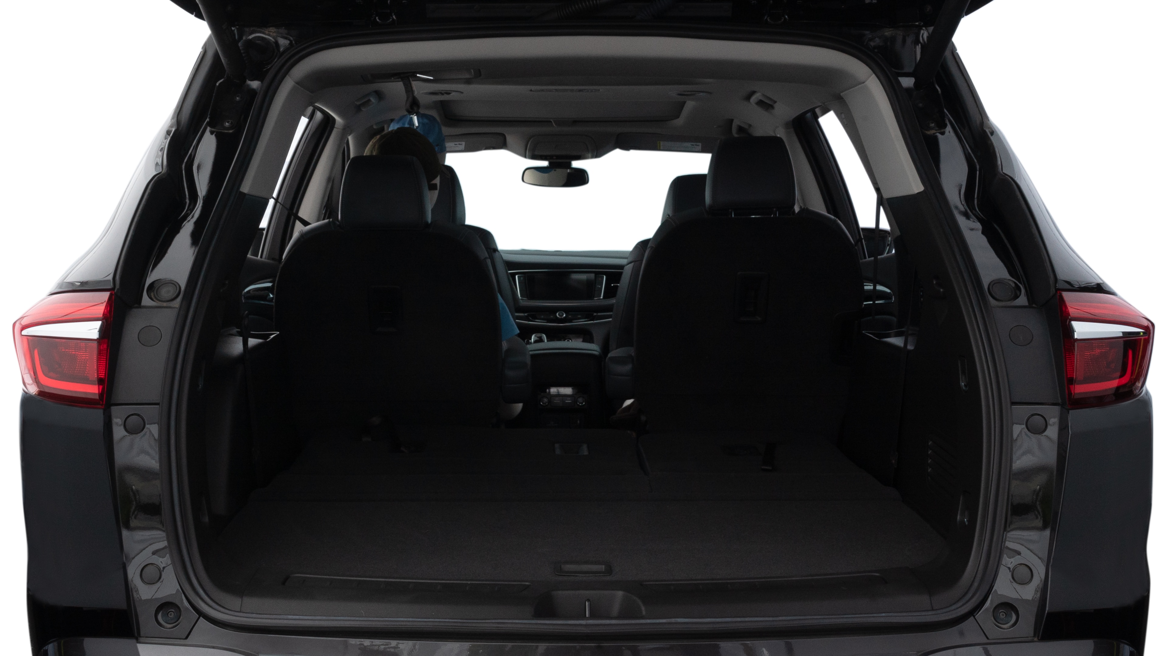 The trunk lid is open showing full view of the trunk. A baby stroller, three grocery carriers, two camping chairs in the carrying bag, and a set of golf clubs are placed inside.