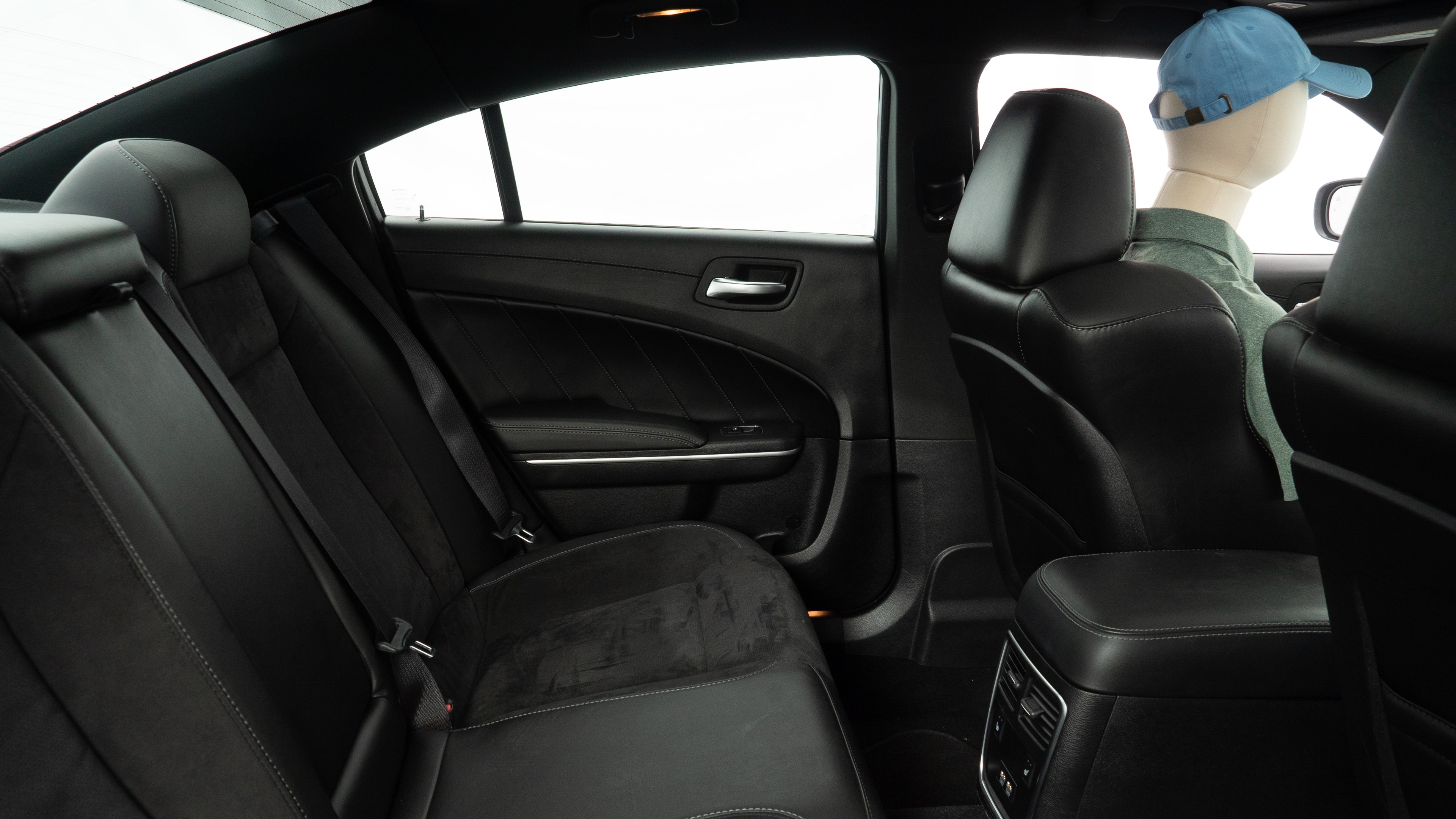 A series of second-row backseat photos is shown including one seating a baby seat and one seating a 6'1" mannequin.