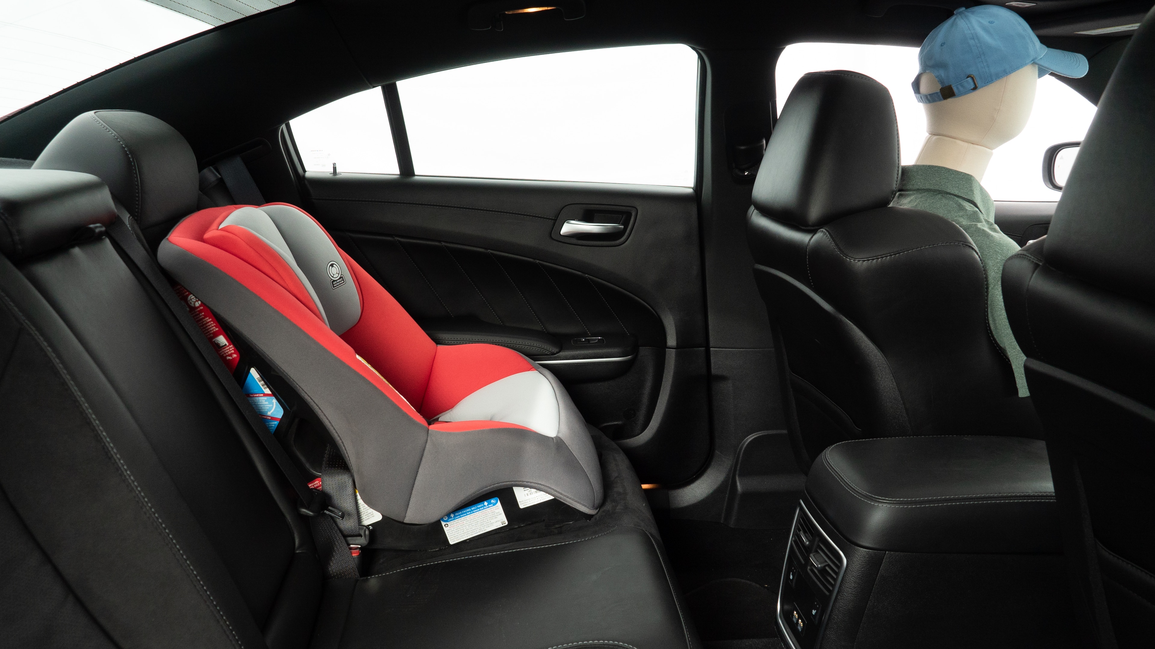 A series of second-row backseat photos is shown including one seating a baby seat and one seating a 6'1" mannequin.