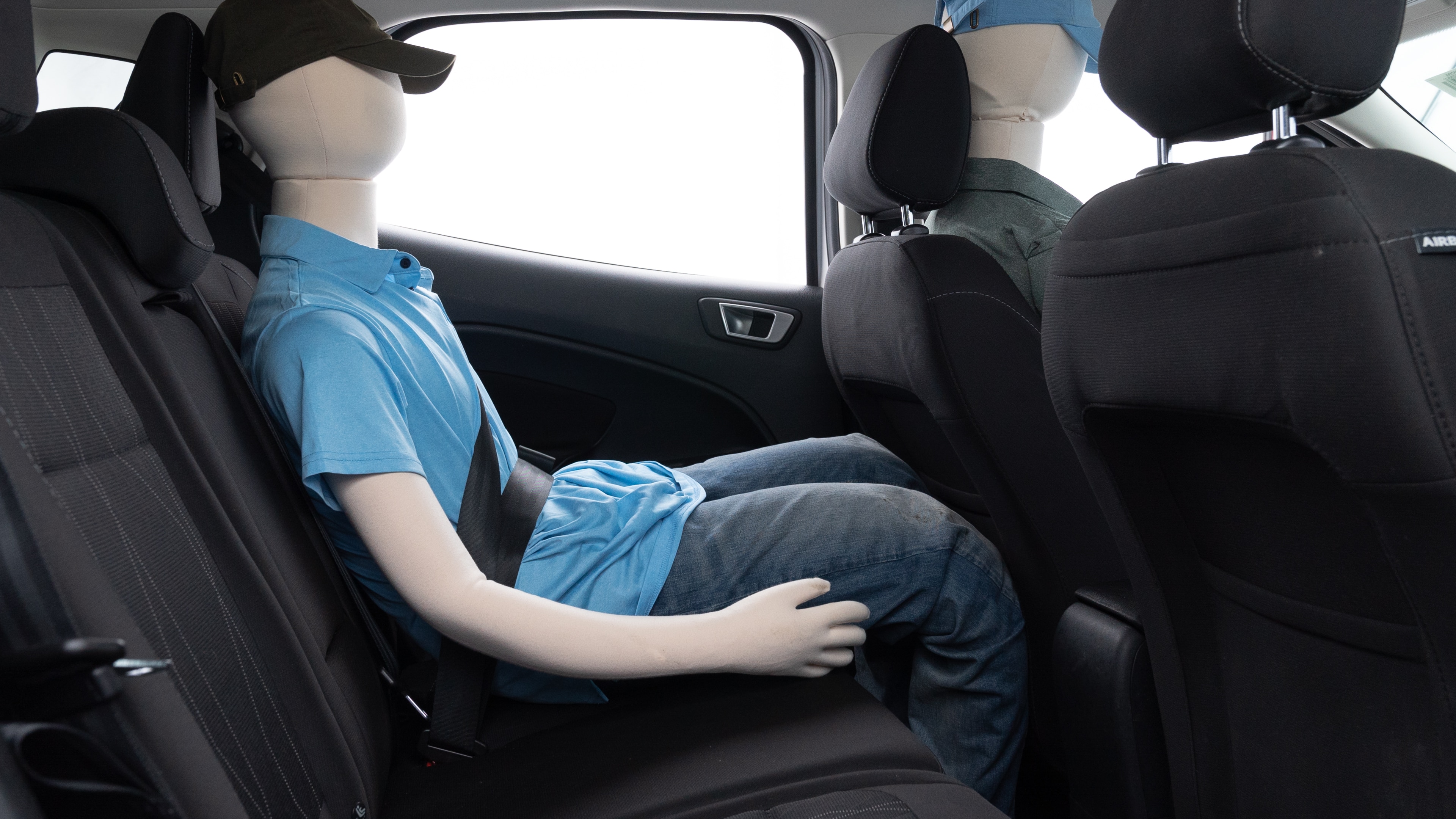 A series of second-row backseat photos is shown including one seating a baby seat and one seating a 6'1" mannequin.