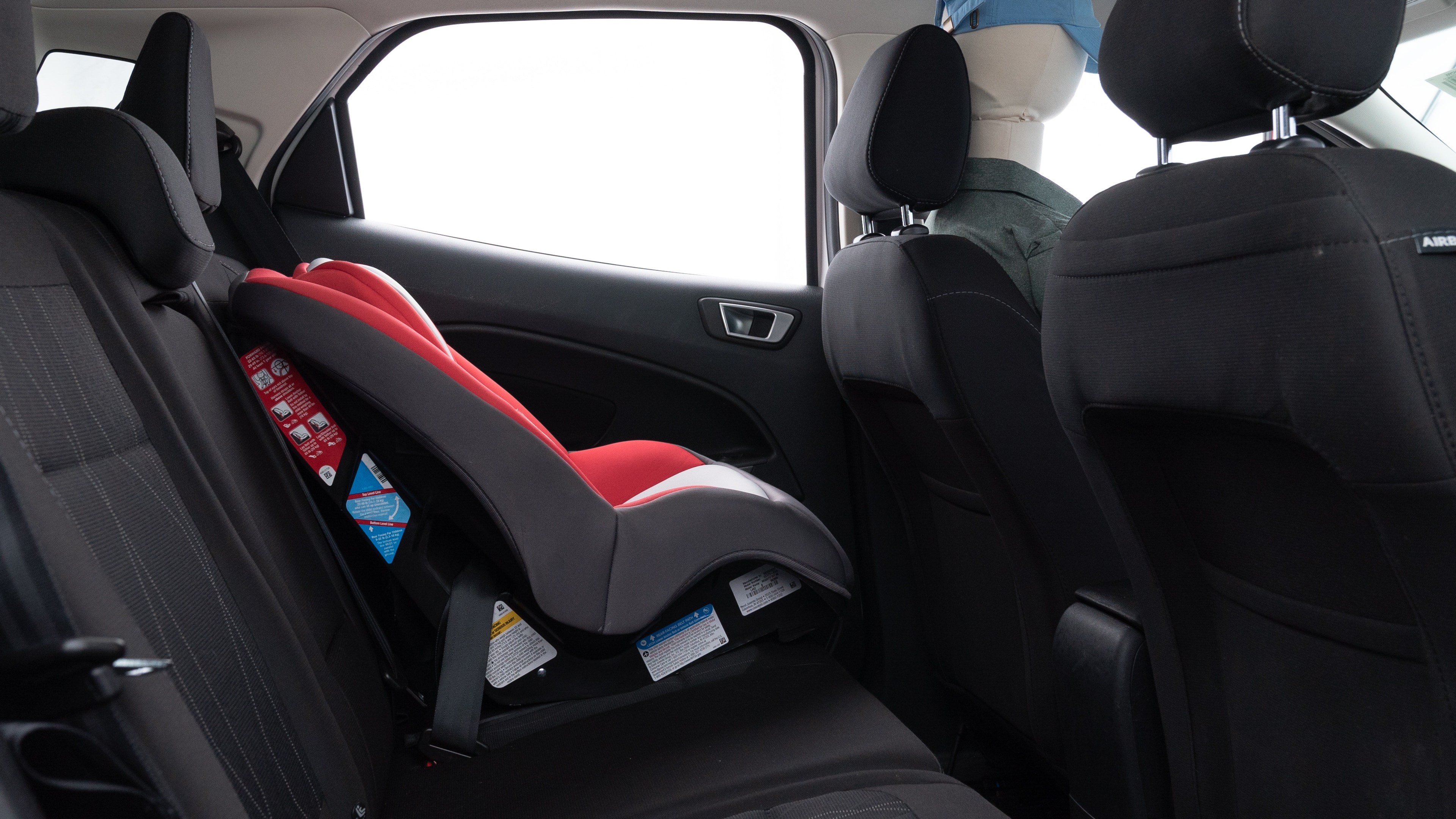 A series of second-row backseat photos is shown including one seating a baby seat and one seating a 6'1" mannequin.