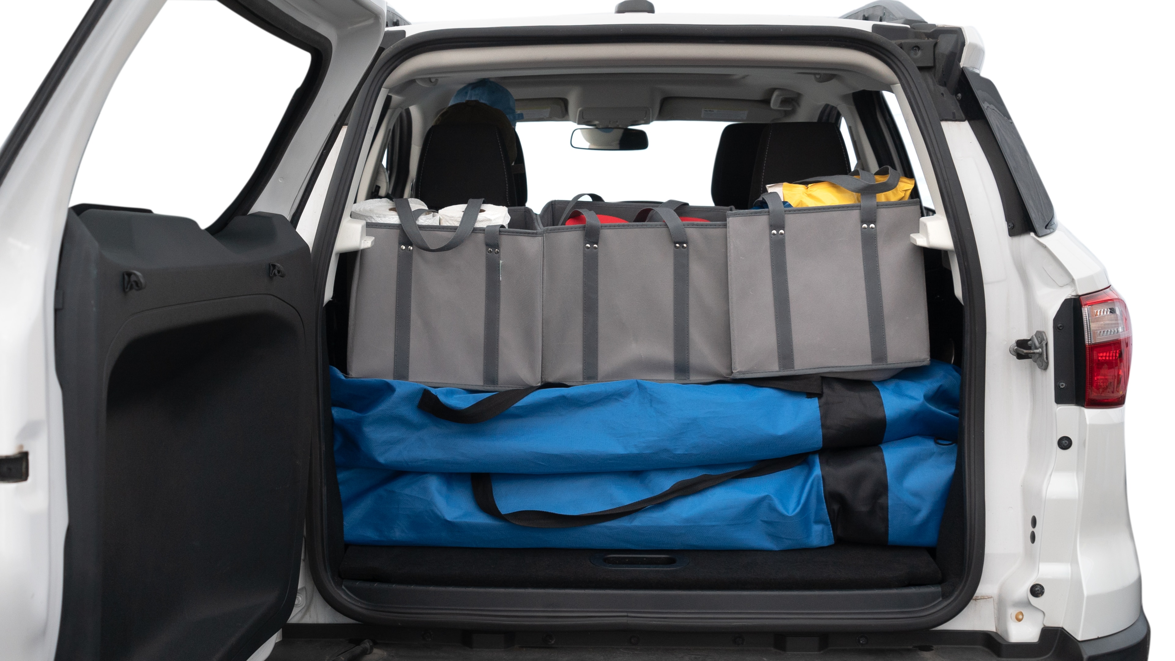 The trunk lid is open showing full view of the trunk. A baby stroller, three grocery carriers, two camping chairs in the carrying bag, and a set of golf clubs are placed inside.