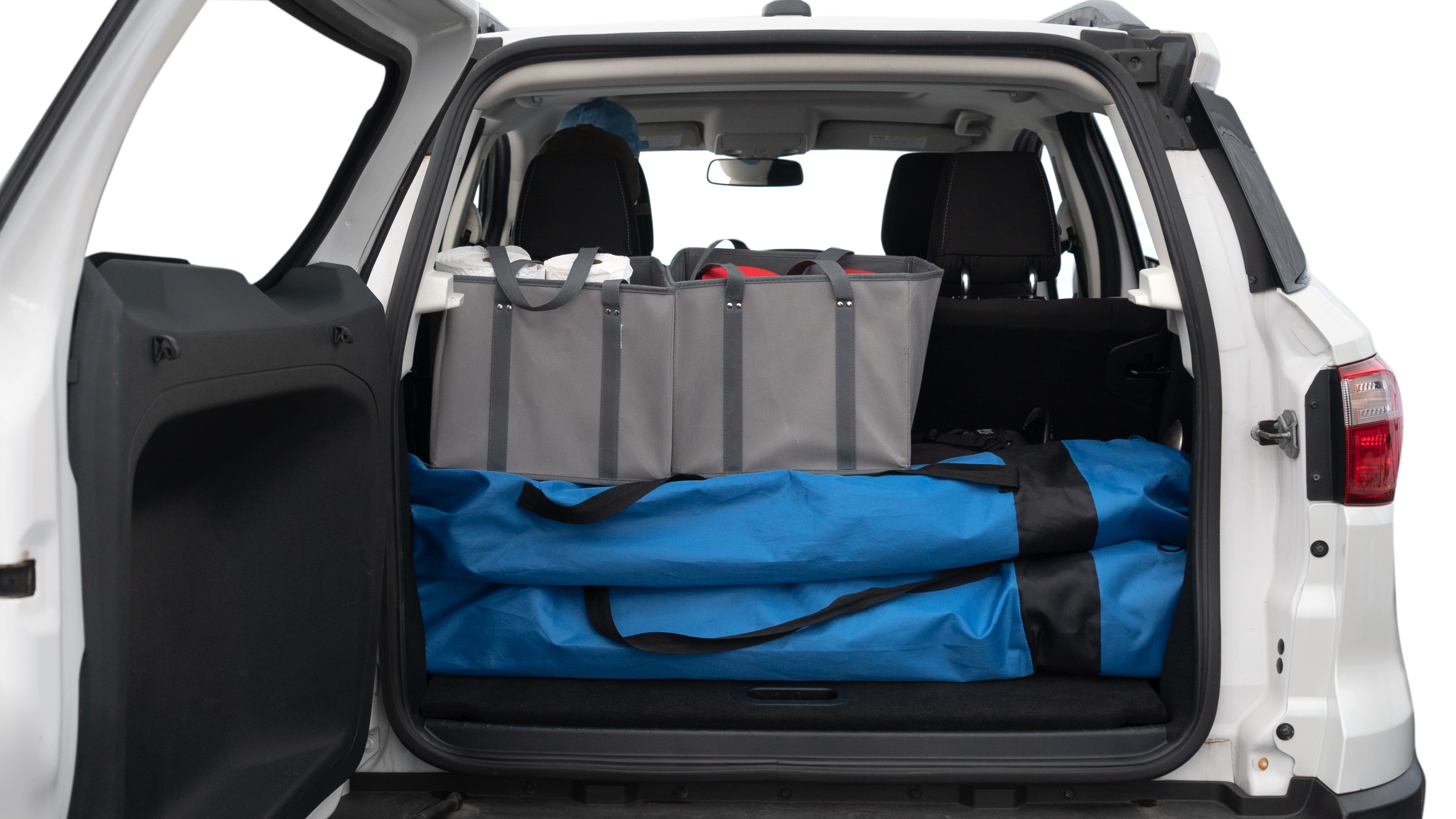 The trunk lid is open showing full view of the trunk. A baby stroller, three grocery carriers, two camping chairs in the carrying bag, and a set of golf clubs are placed inside.