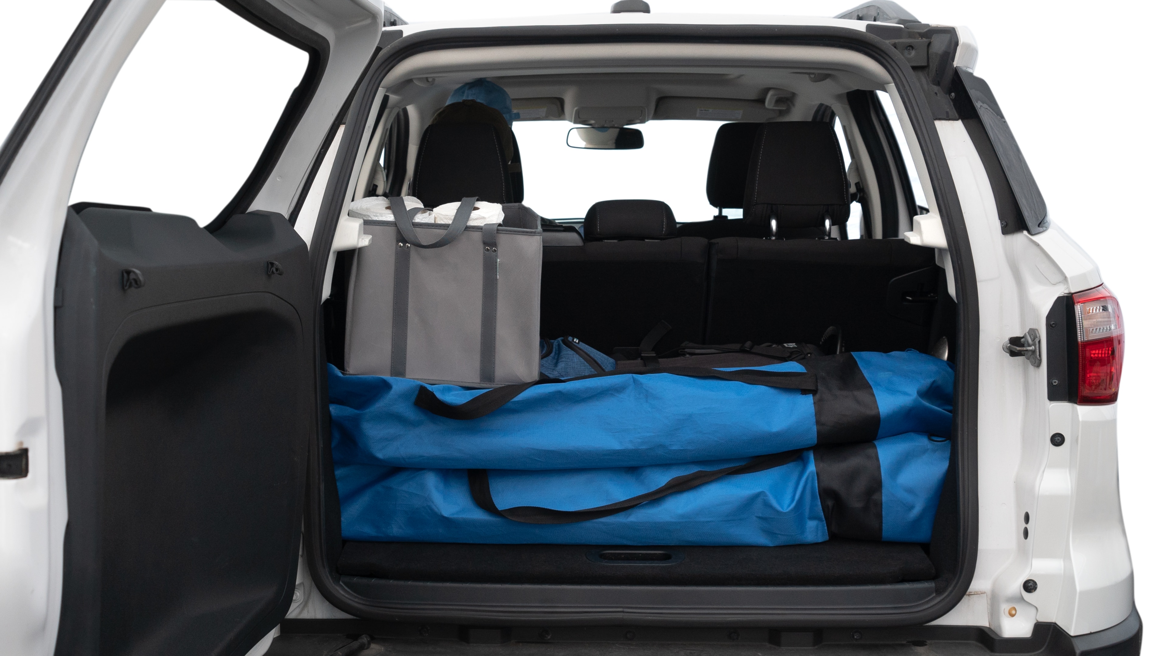 The trunk lid is open showing full view of the trunk. A baby stroller, three grocery carriers, two camping chairs in the carrying bag, and a set of golf clubs are placed inside.