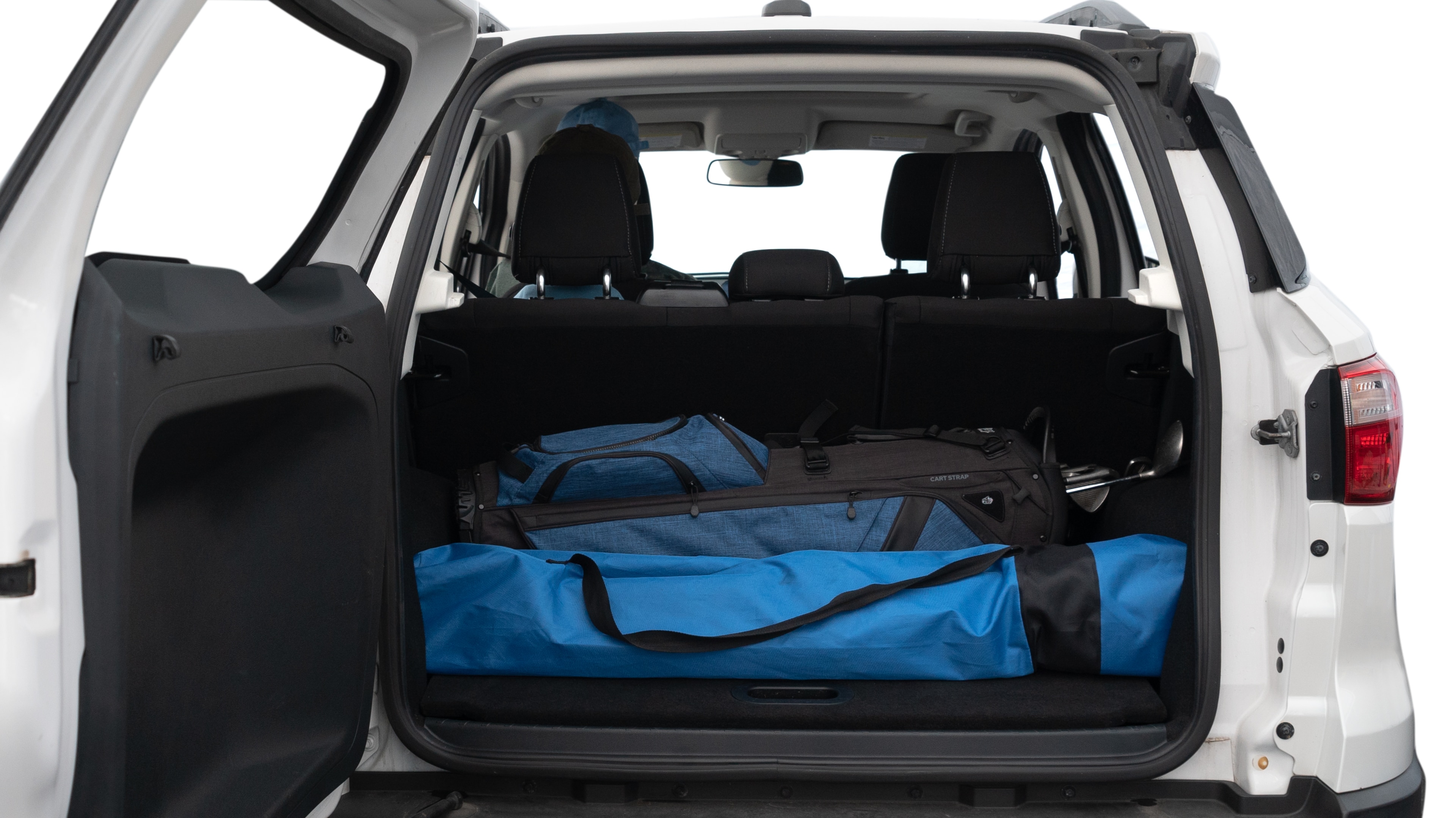 The trunk lid is open showing full view of the trunk. A baby stroller, three grocery carriers, two camping chairs in the carrying bag, and a set of golf clubs are placed inside.