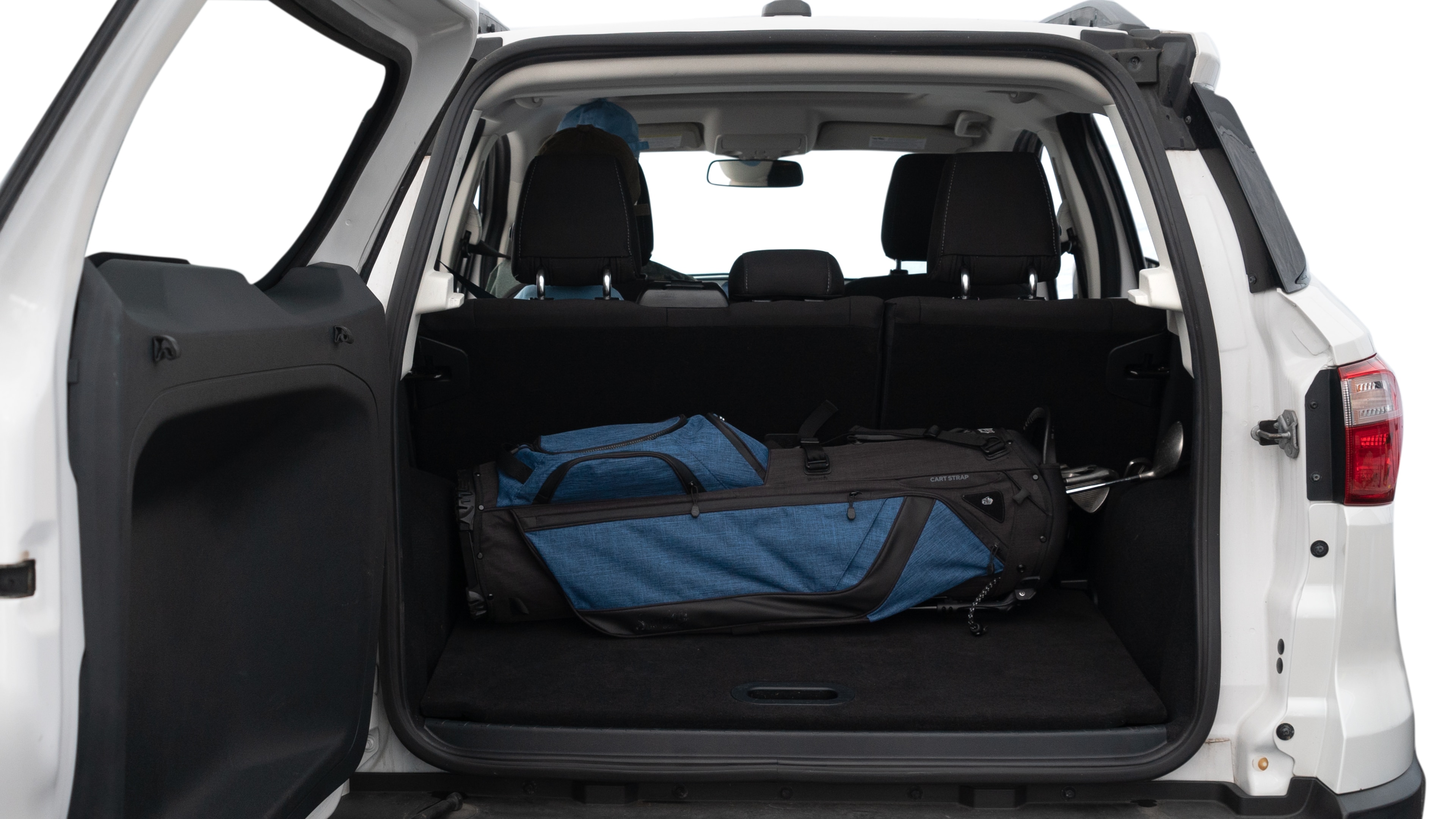 The trunk lid is open showing full view of the trunk. A baby stroller, three grocery carriers, two camping chairs in the carrying bag, and a set of golf clubs are placed inside.