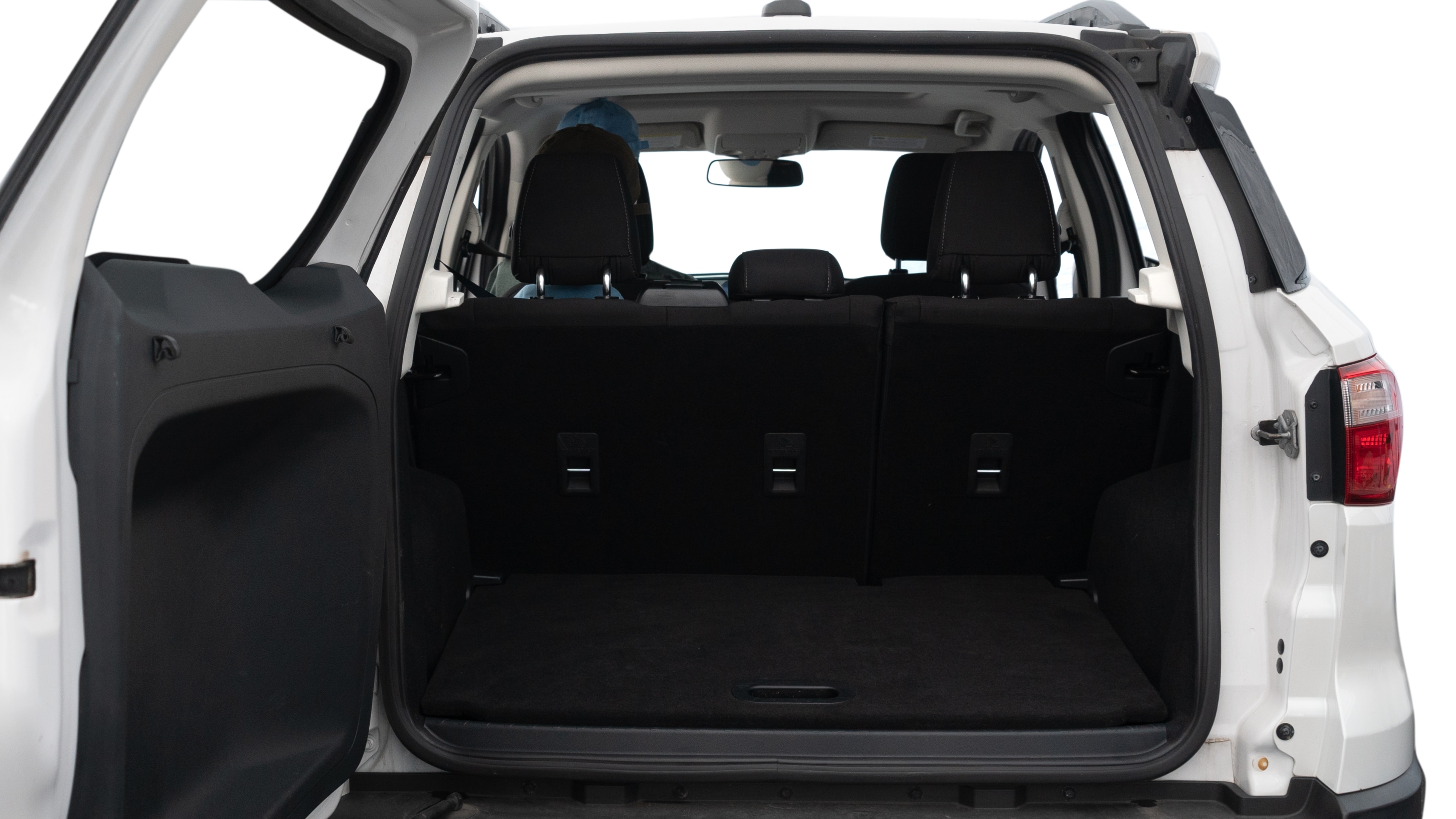 The trunk lid is open, showing full view of the trunk space. Two medium and two small suitcases are placed inside.