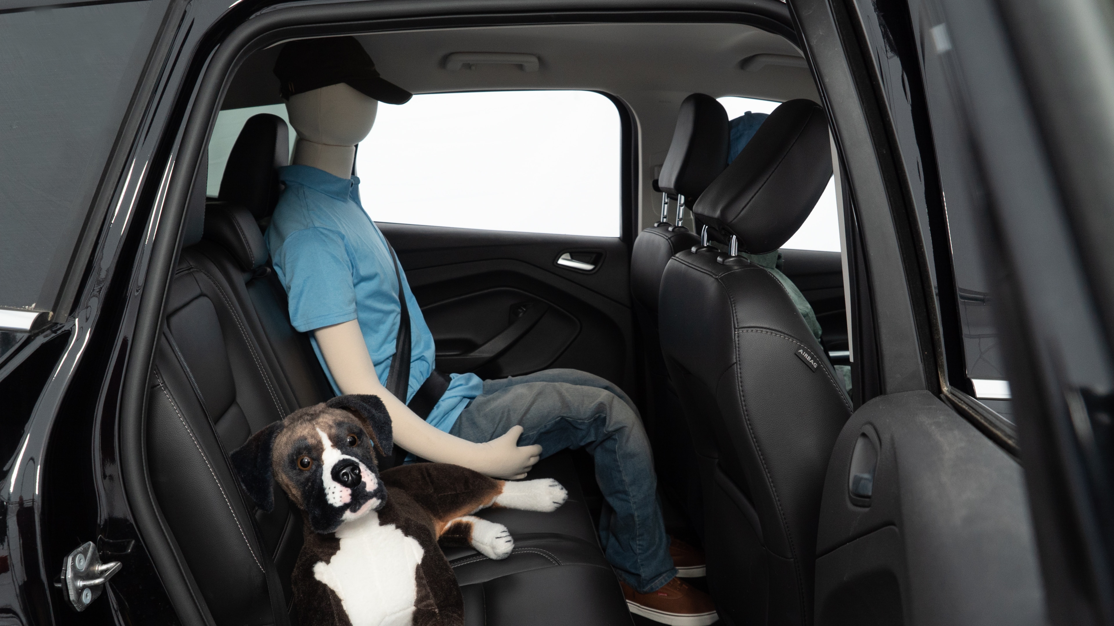 A series of second-row backseat photos is shown including one seating a baby seat and one seating a 6'1" mannequin.