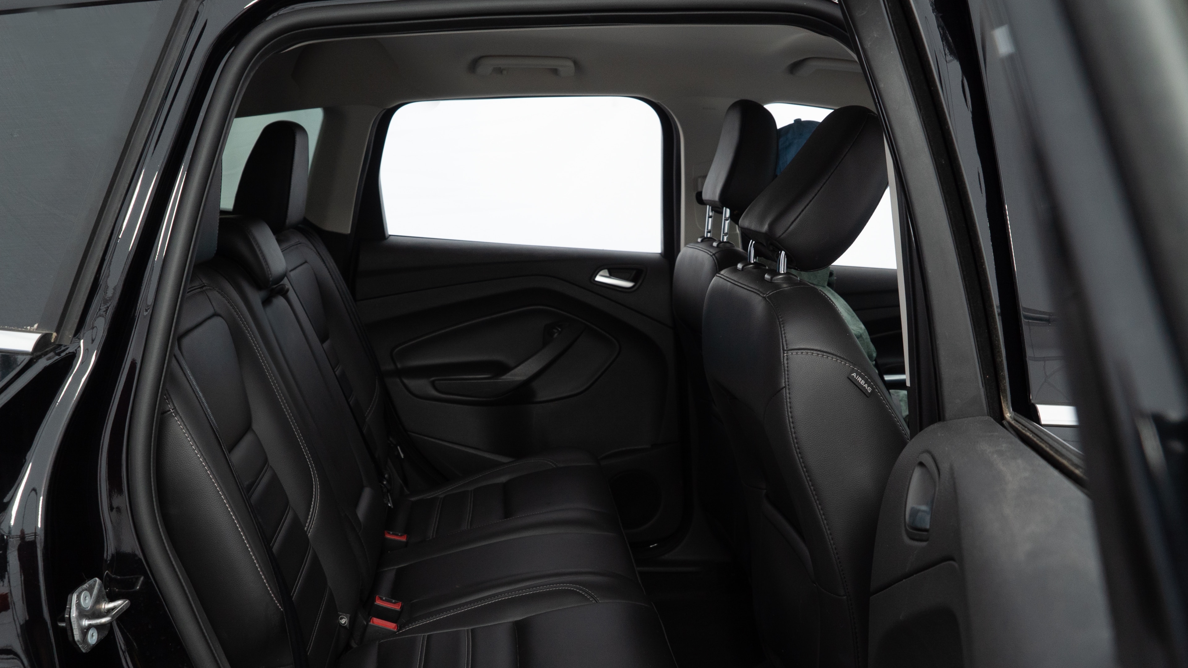 A series of second-row backseat photos is shown including one seating a baby seat and one seating a 6'1" mannequin.