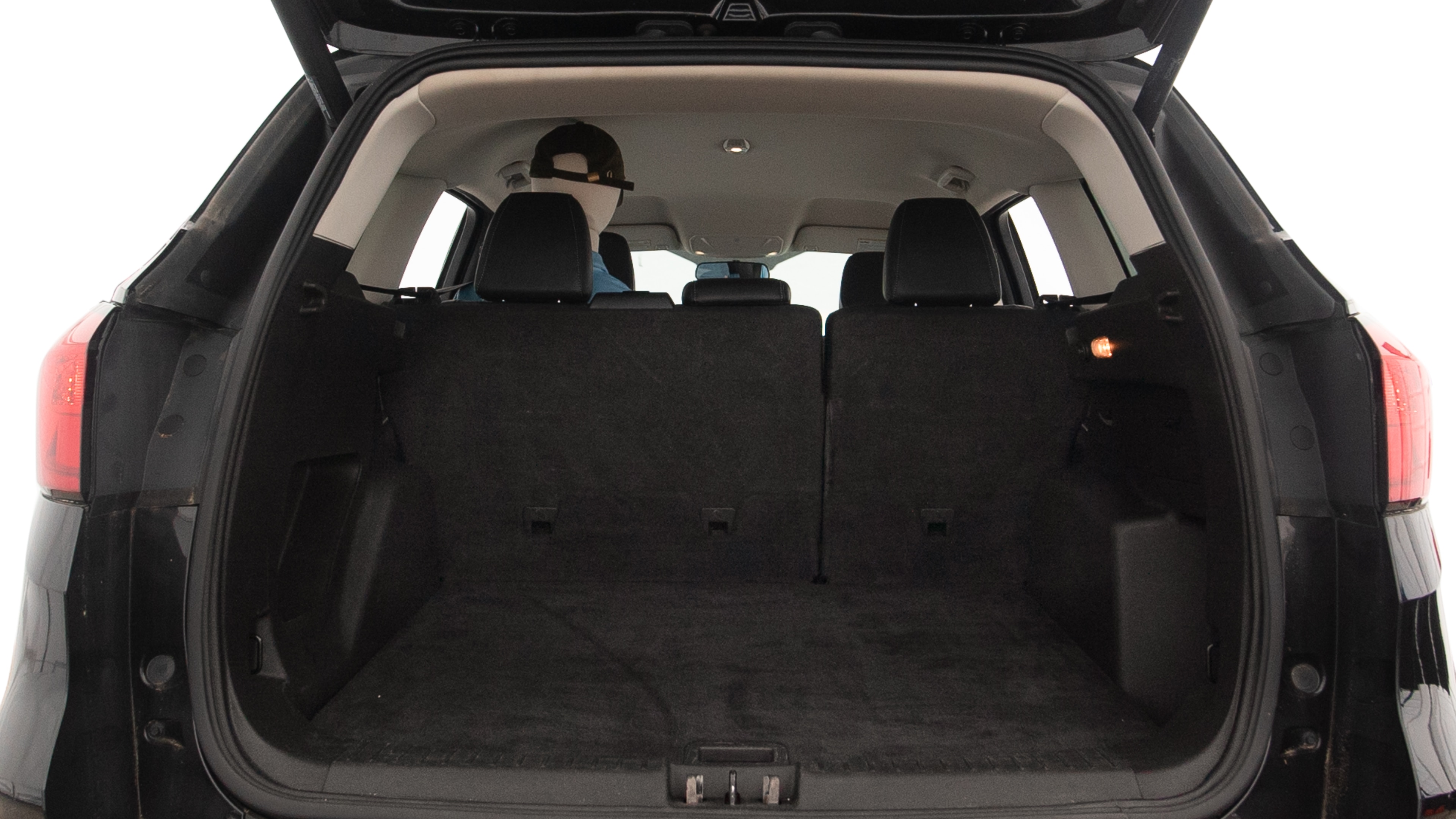 The trunk lid is open showing full view of the trunk. A baby stroller, three grocery carriers, two camping chairs in the carrying bag, and a set of golf clubs are placed inside.