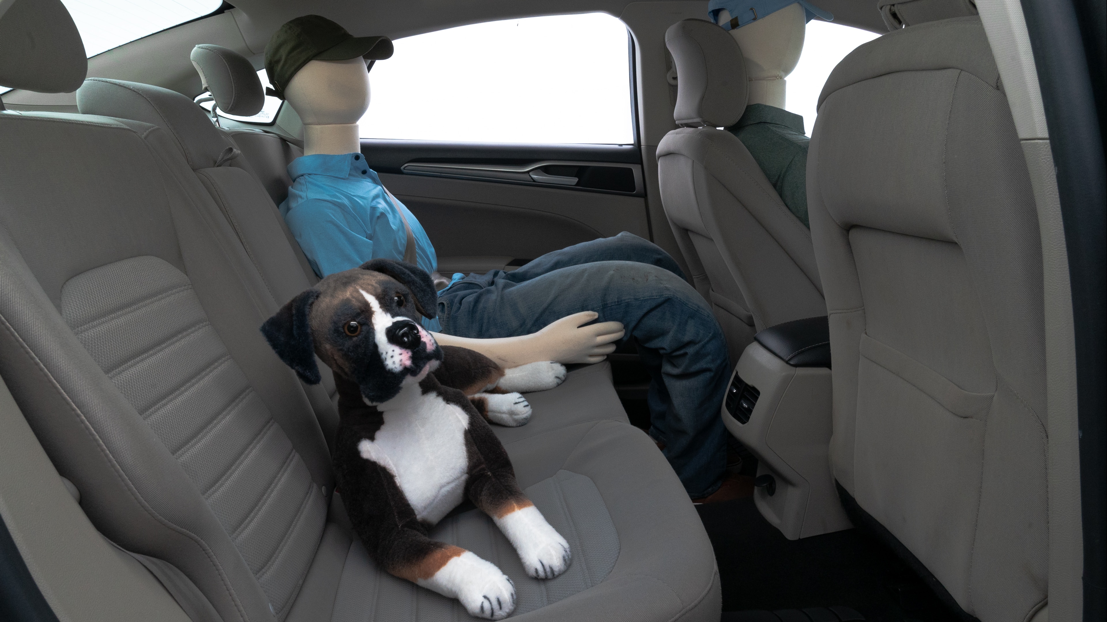 A series of second-row backseat photos is shown including one seating a baby seat and one seating a 6'1" mannequin.