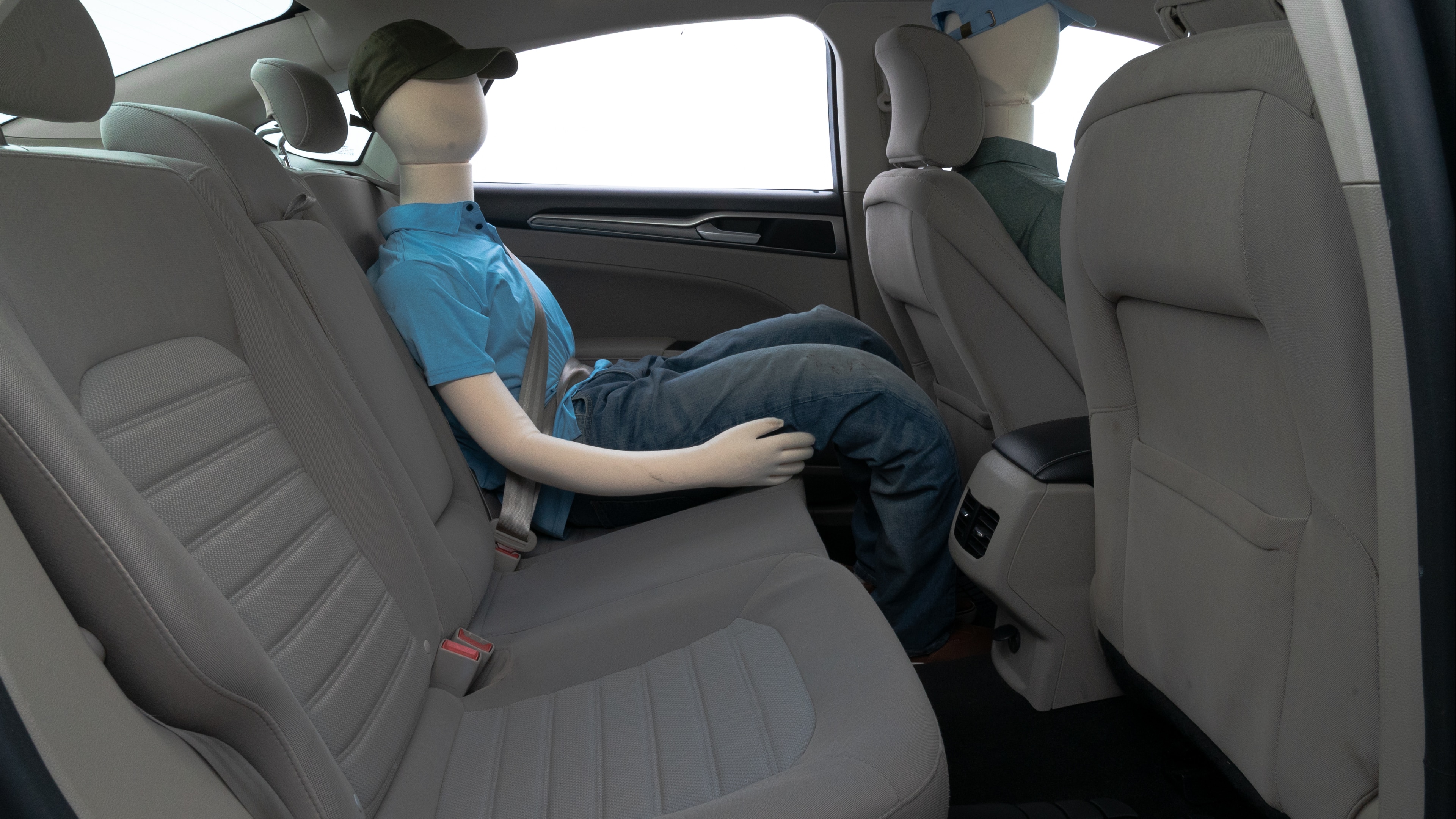A series of second-row backseat photos is shown including one seating a baby seat and one seating a 6'1" mannequin.