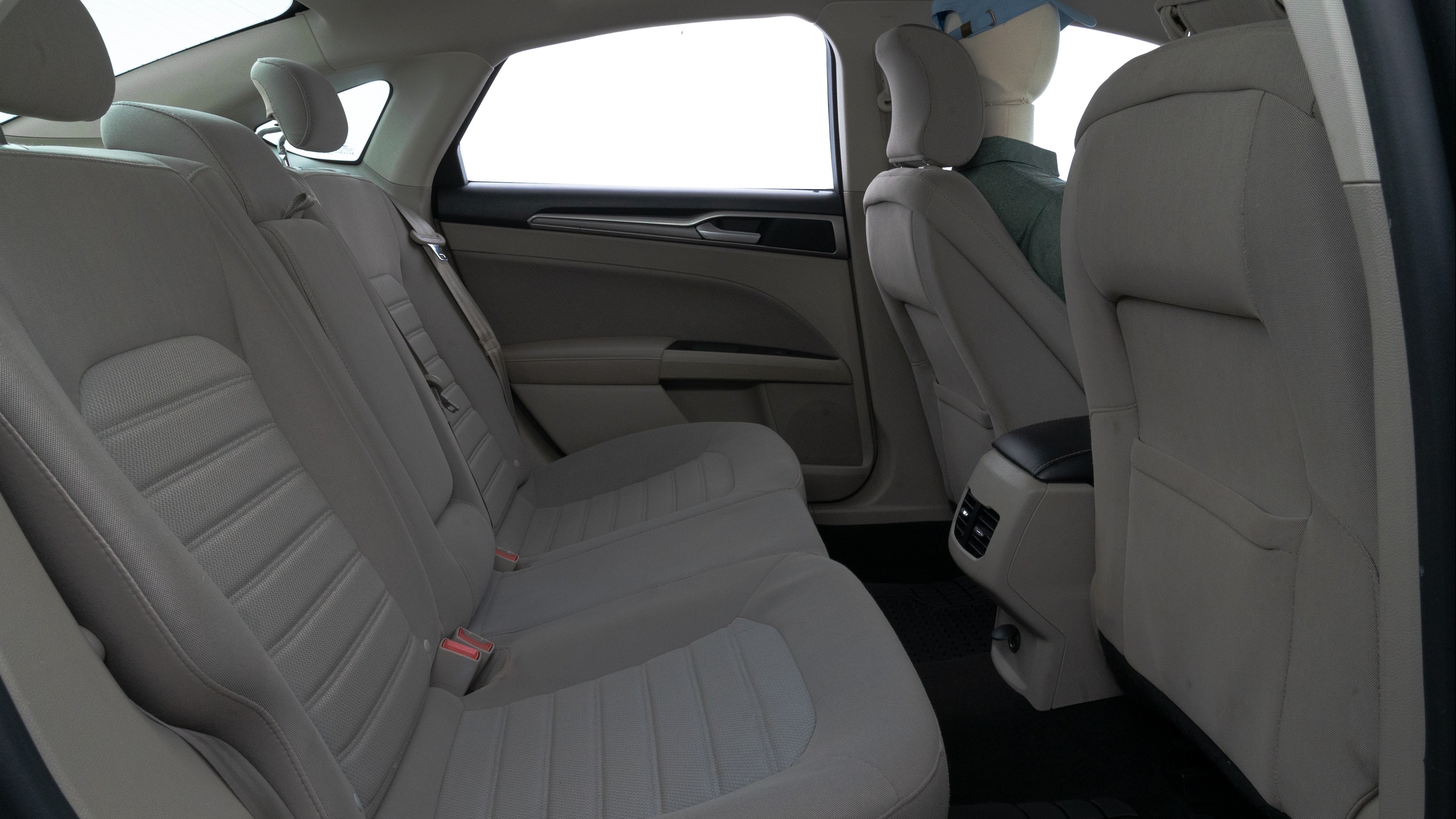 A series of second-row backseat photos is shown including one seating a baby seat and one seating a 6'1" mannequin.