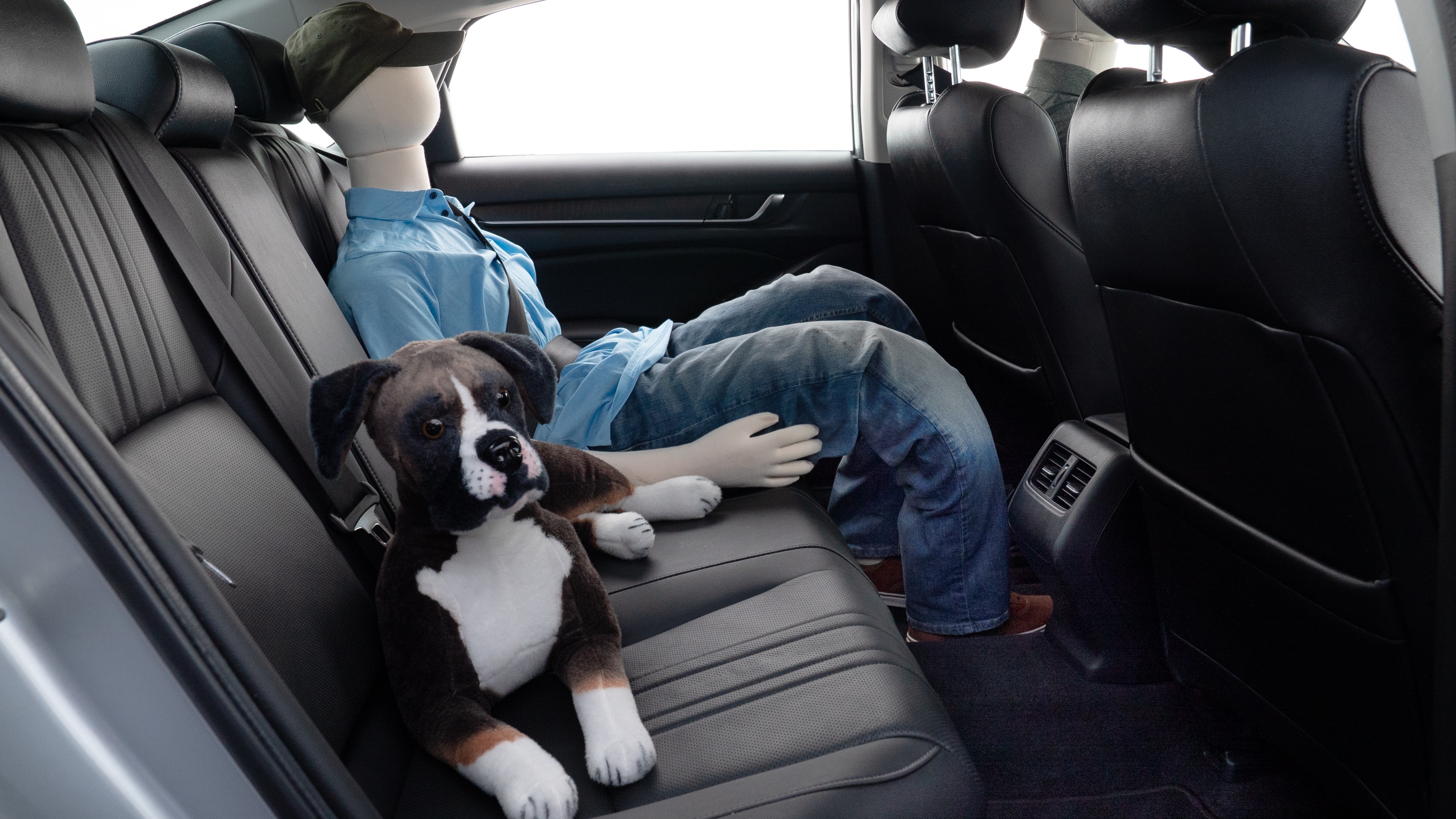 A series of second-row backseat photos is shown including one seating a baby seat and one seating a 6'1" mannequin.