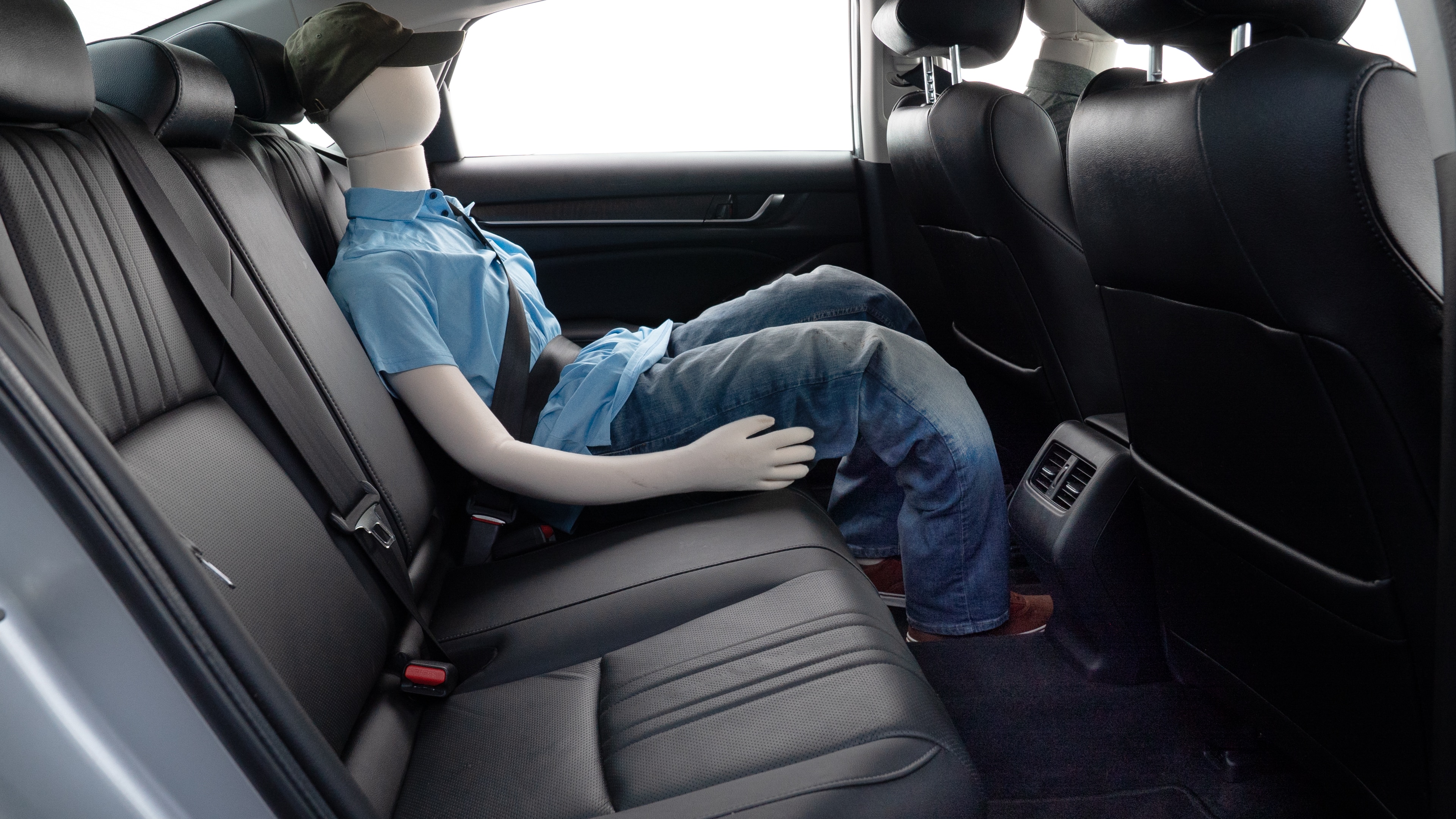 A series of second-row backseat photos is shown including one seating a baby seat and one seating a 6'1" mannequin.