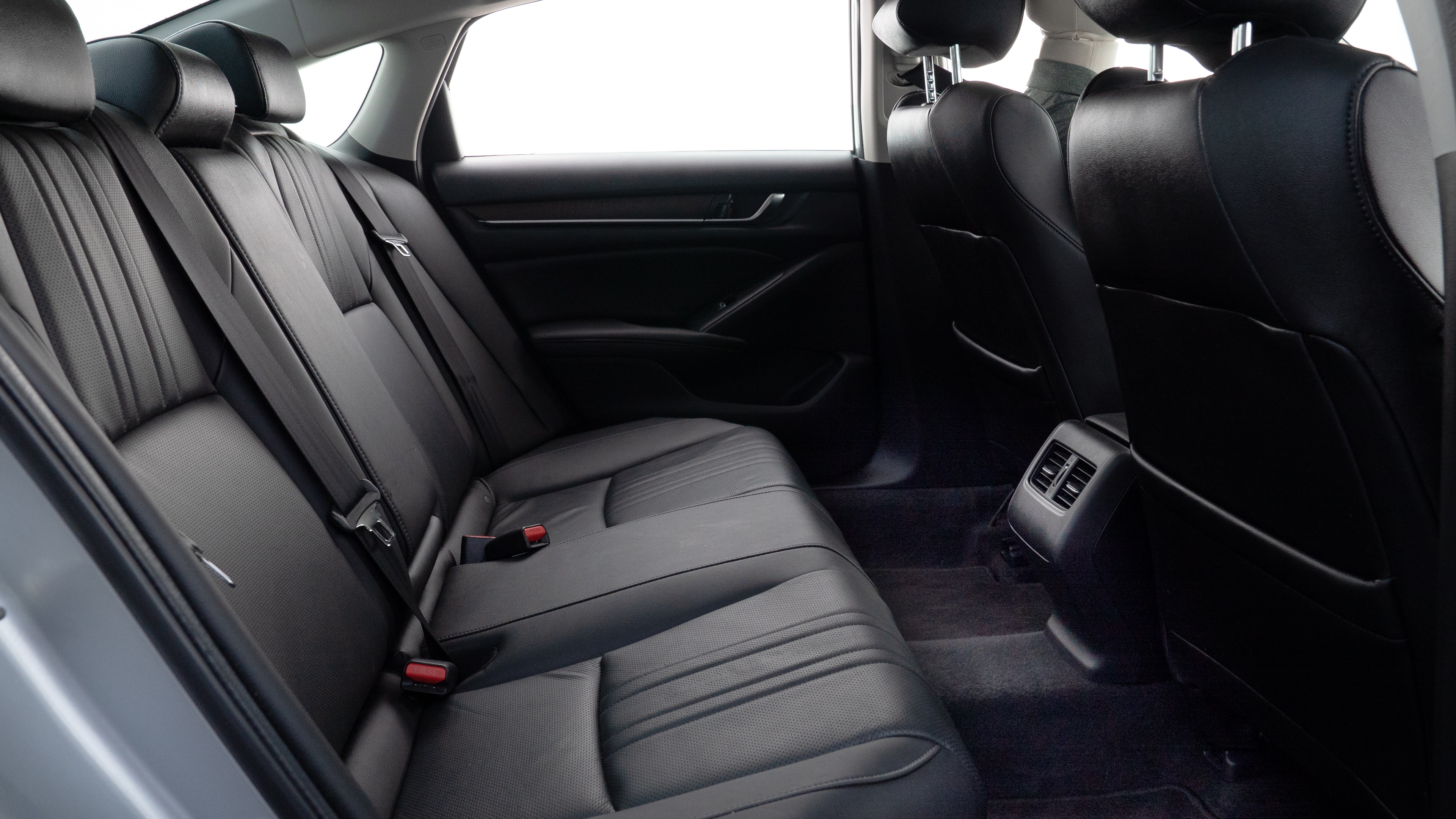 A series of second-row backseat photos is shown including one seating a baby seat and one seating a 6'1" mannequin.
