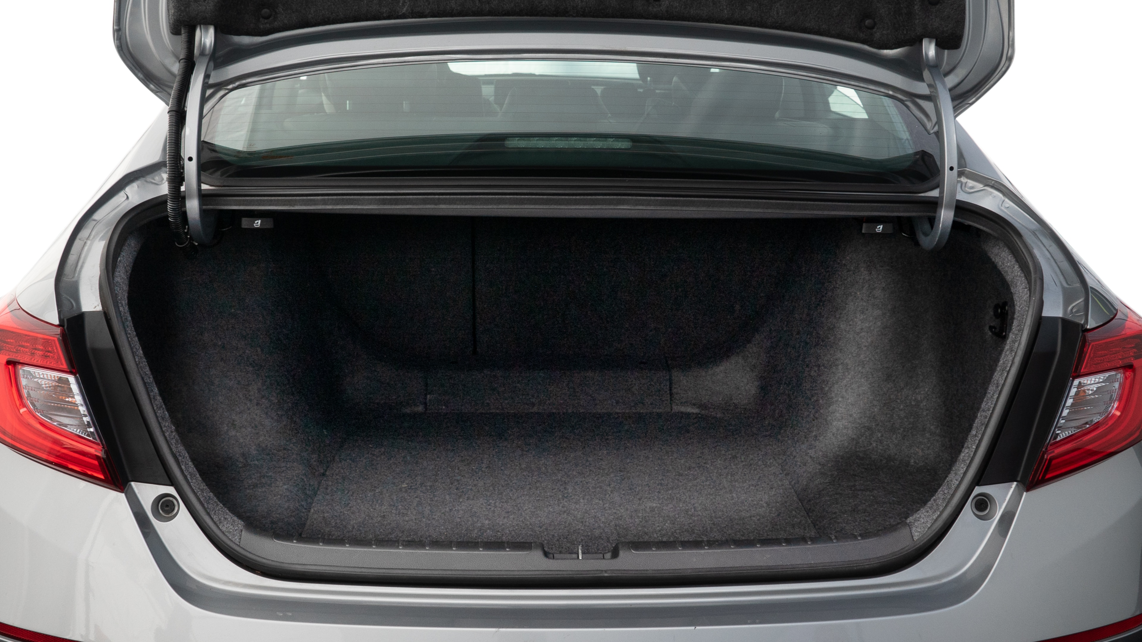 The trunk lid is open showing full view of the trunk. A baby stroller, three grocery carriers, two camping chairs in the carrying bag, and a set of golf clubs are placed inside.