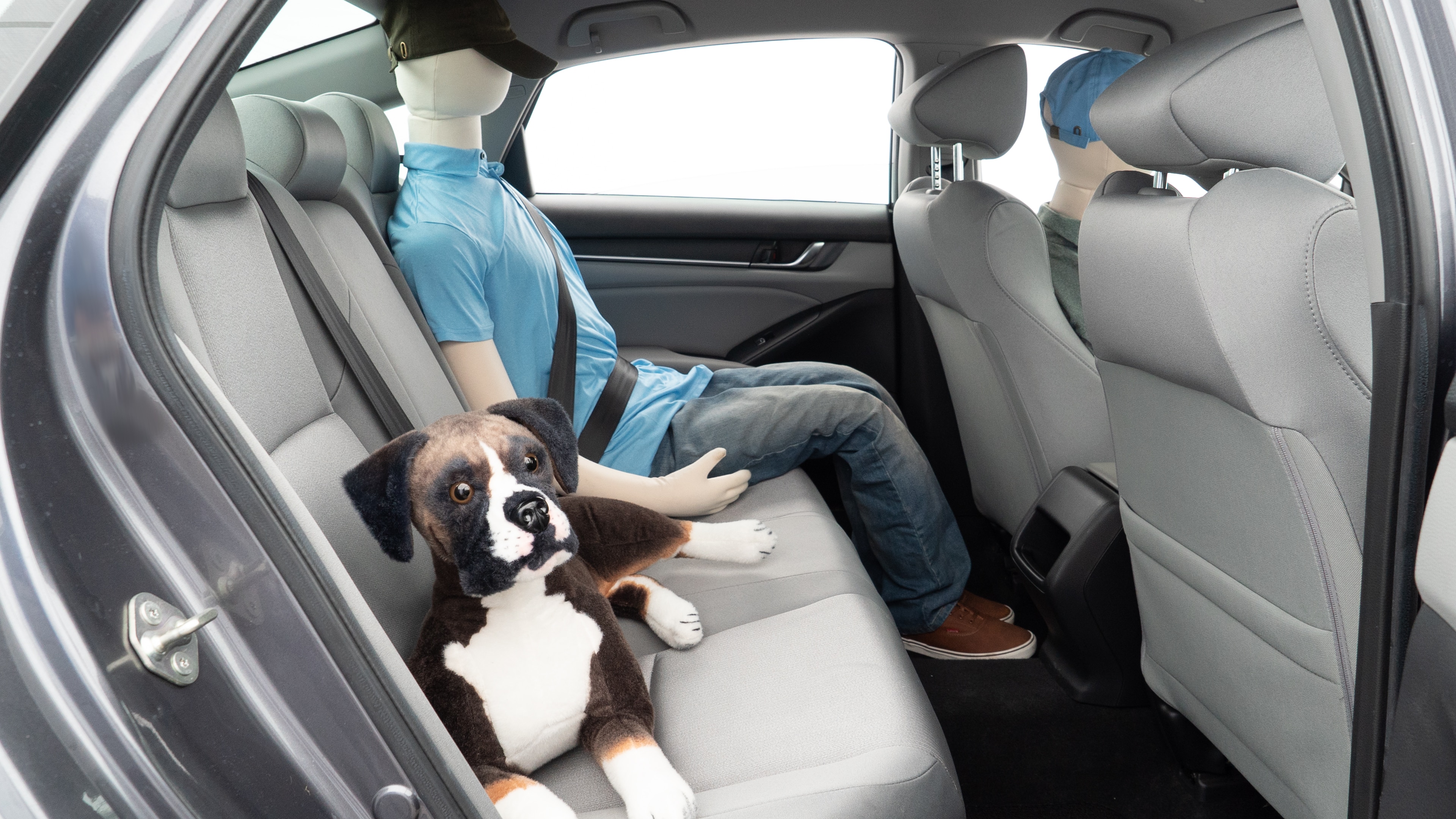 A series of second-row backseat photos is shown including one seating a baby seat and one seating a 6'1" mannequin.