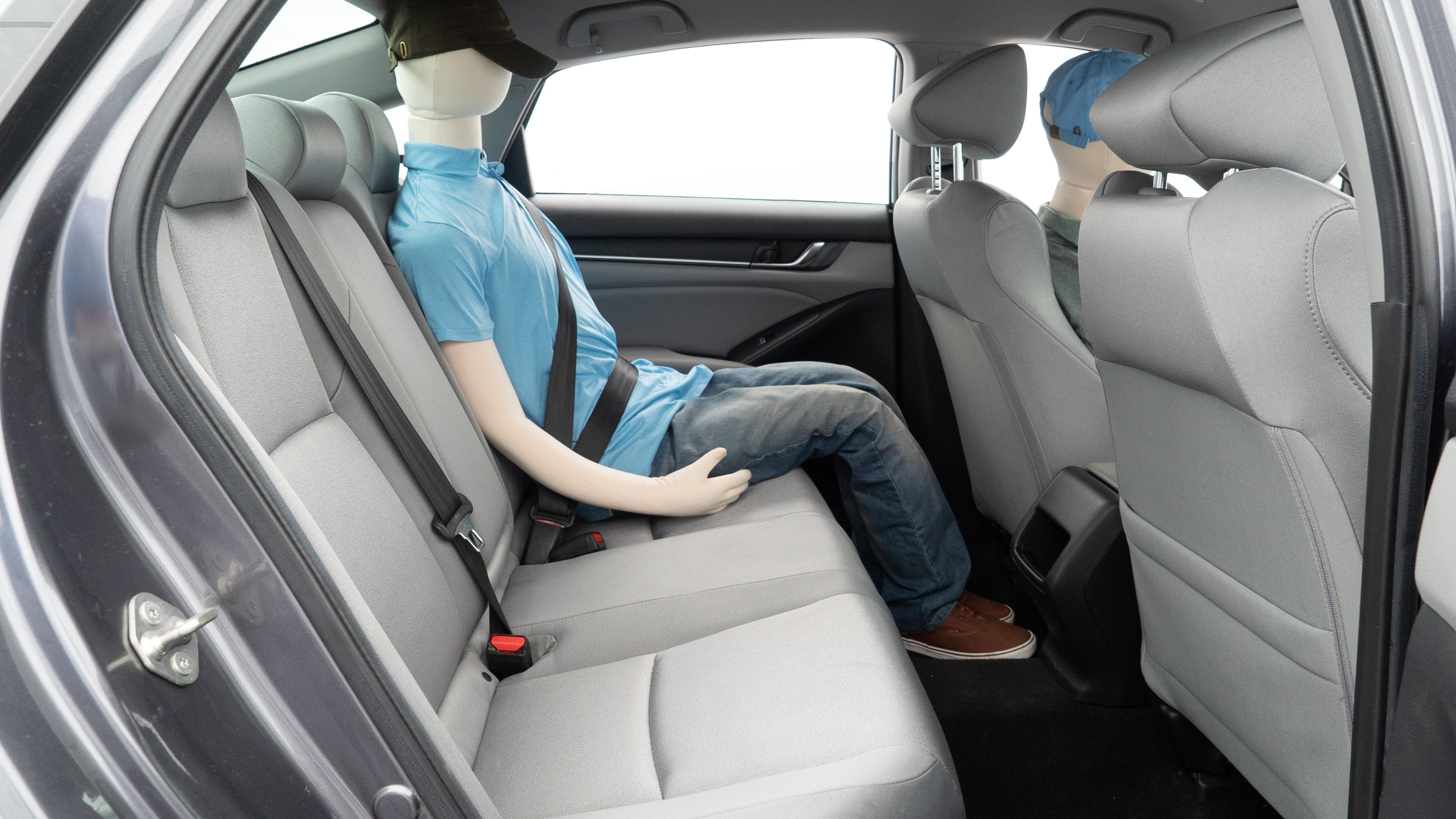 A series of second-row backseat photos is shown including one seating a baby seat and one seating a 6'1" mannequin.