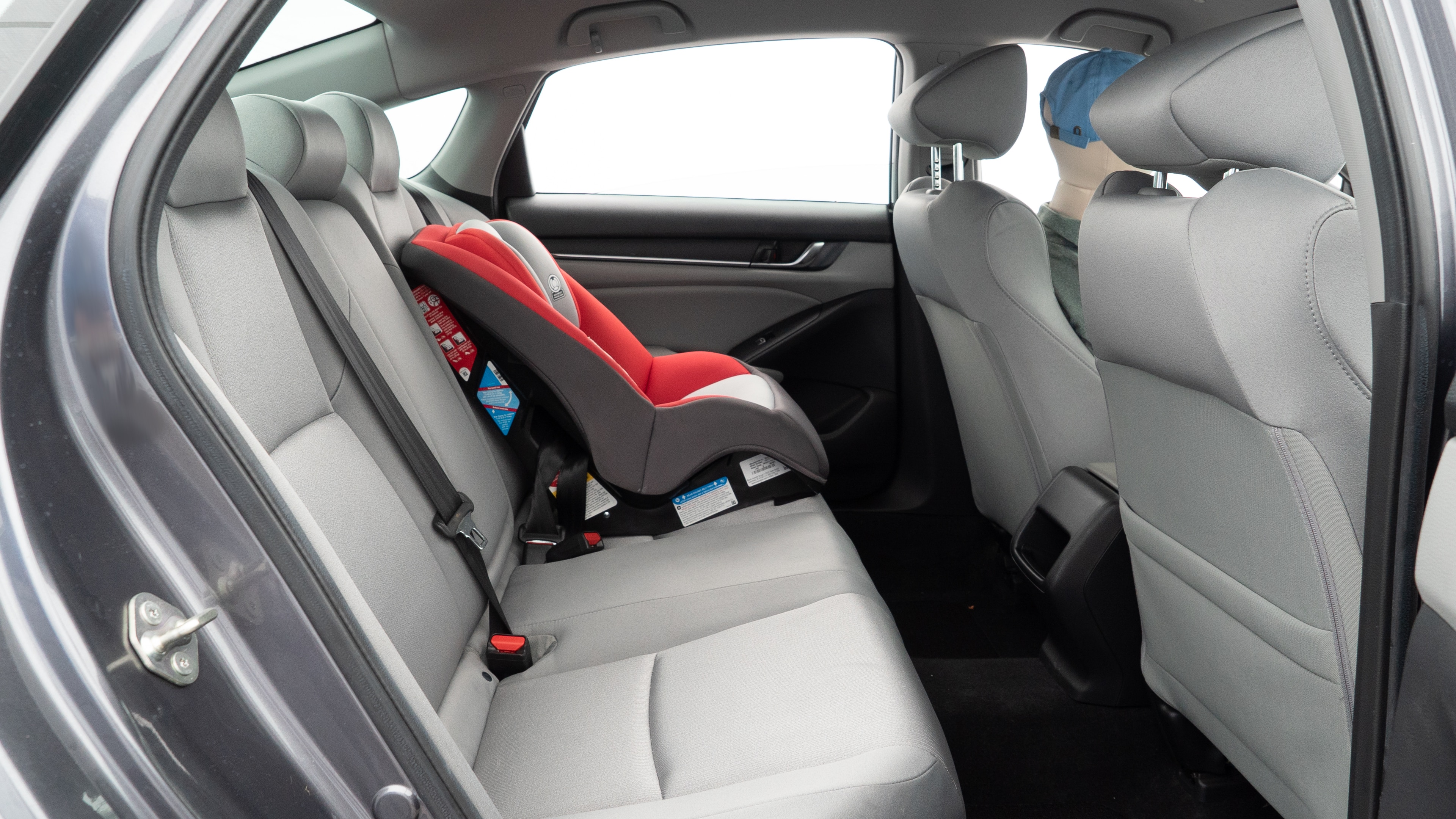 A series of second-row backseat photos is shown including one seating a baby seat and one seating a 6'1" mannequin.