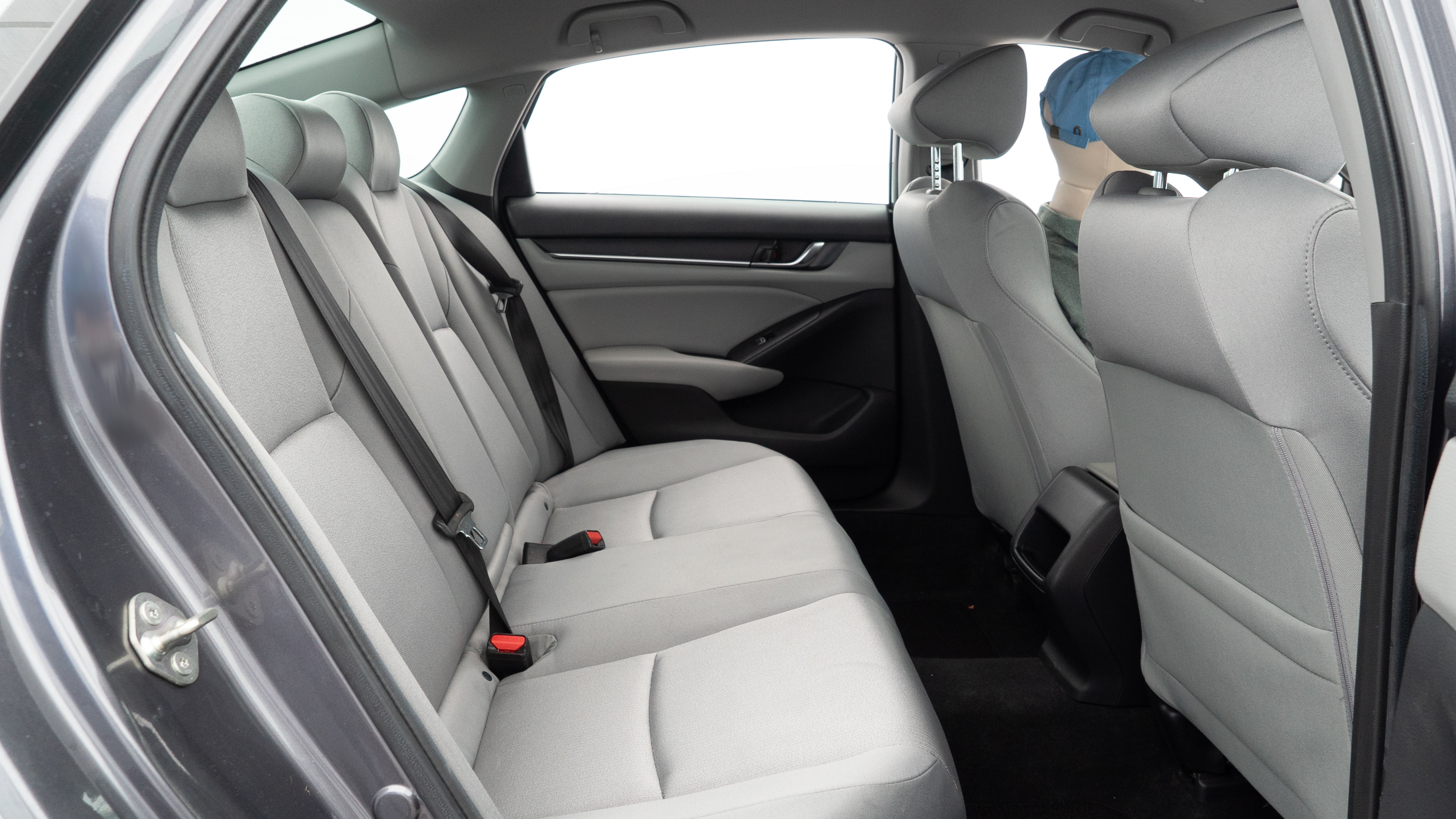 A series of second-row backseat photos is shown including one seating a baby seat and one seating a 6'1" mannequin.