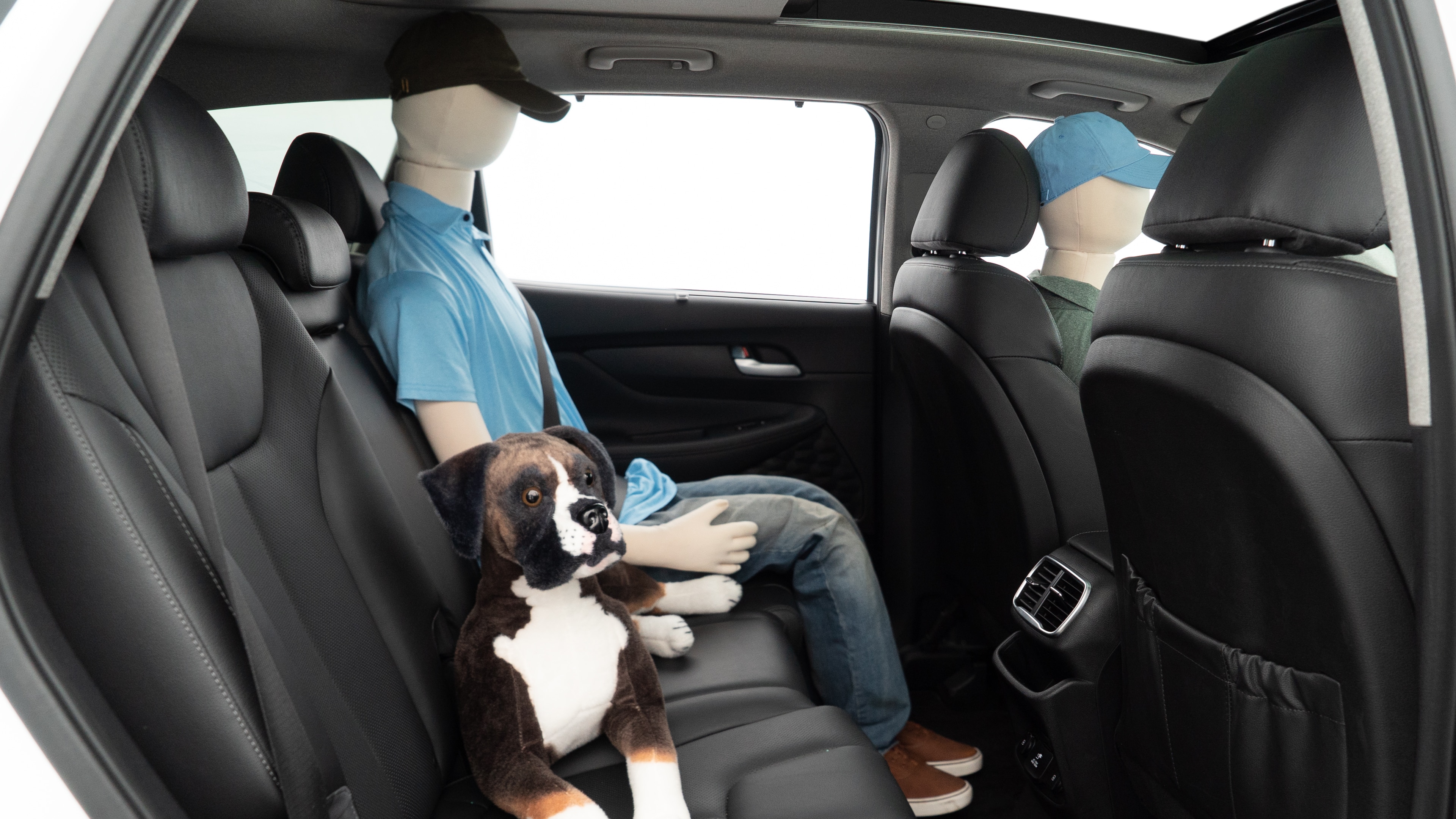 A series of second-row backseat photos is shown including one seating a baby seat and one seating a 6'1" mannequin.