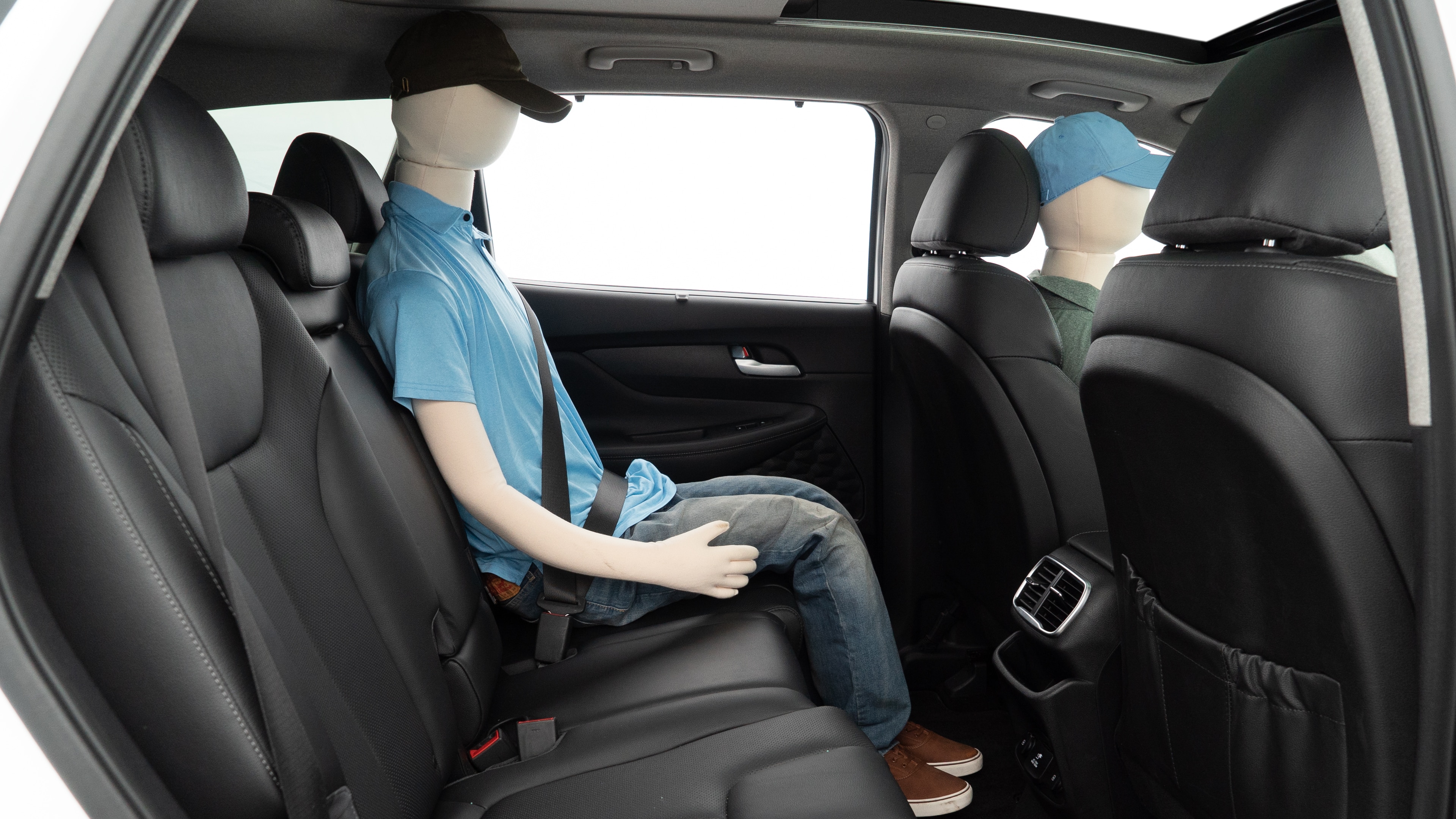 A series of second-row backseat photos is shown including one seating a baby seat and one seating a 6'1" mannequin.