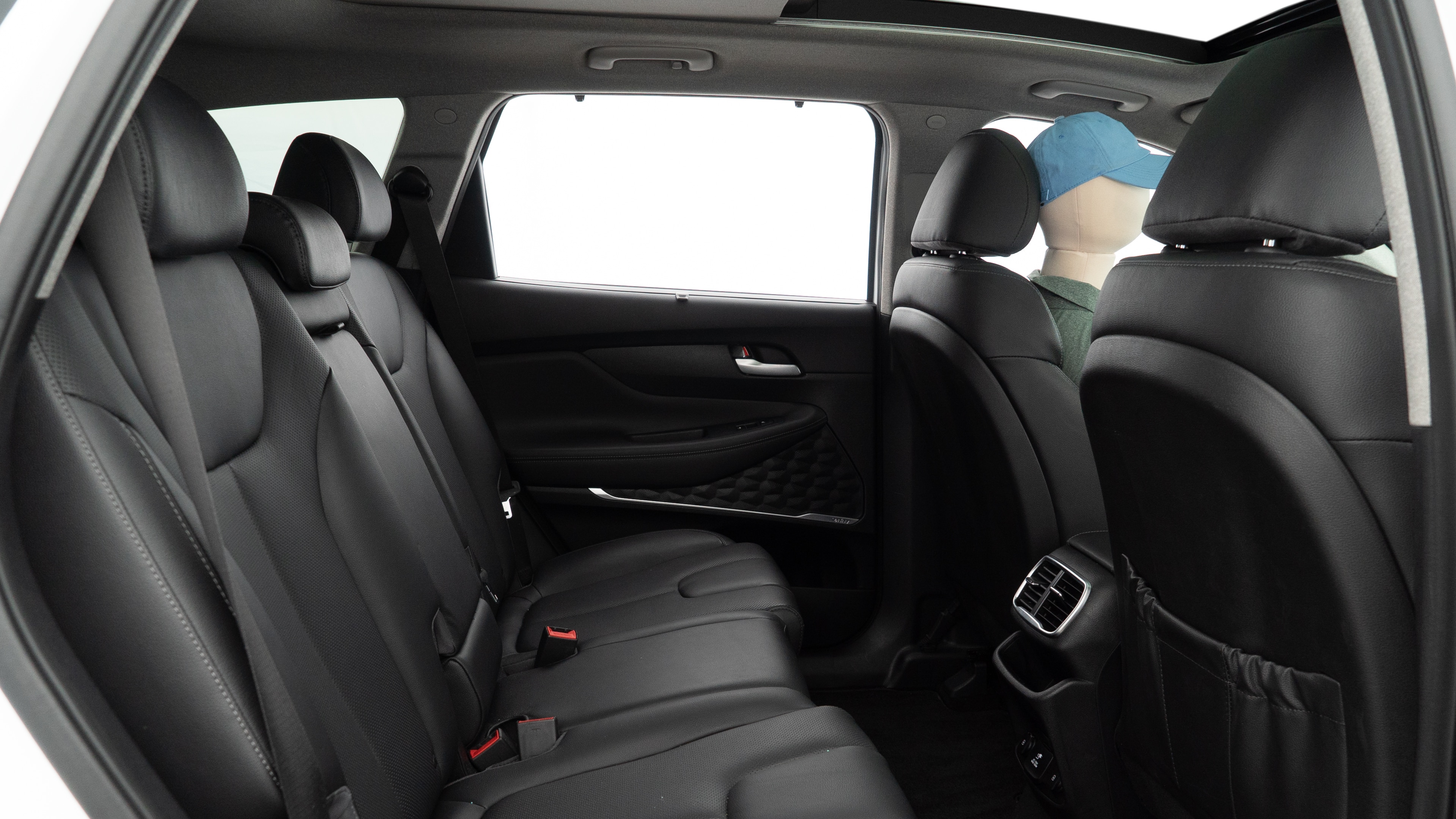 A series of second-row backseat photos is shown including one seating a baby seat and one seating a 6'1" mannequin.