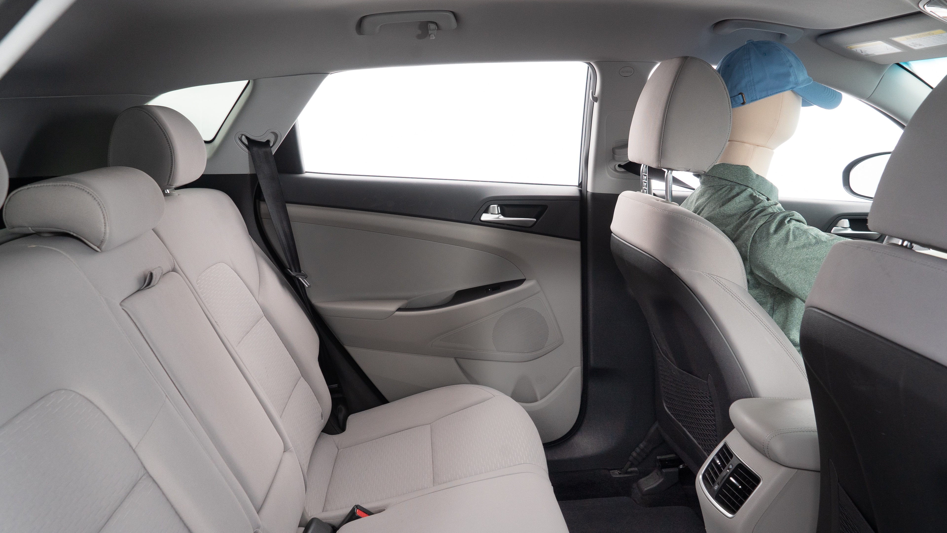 A series of second-row backseat photos is shown including one seating a baby seat and one seating a 6'1" mannequin.