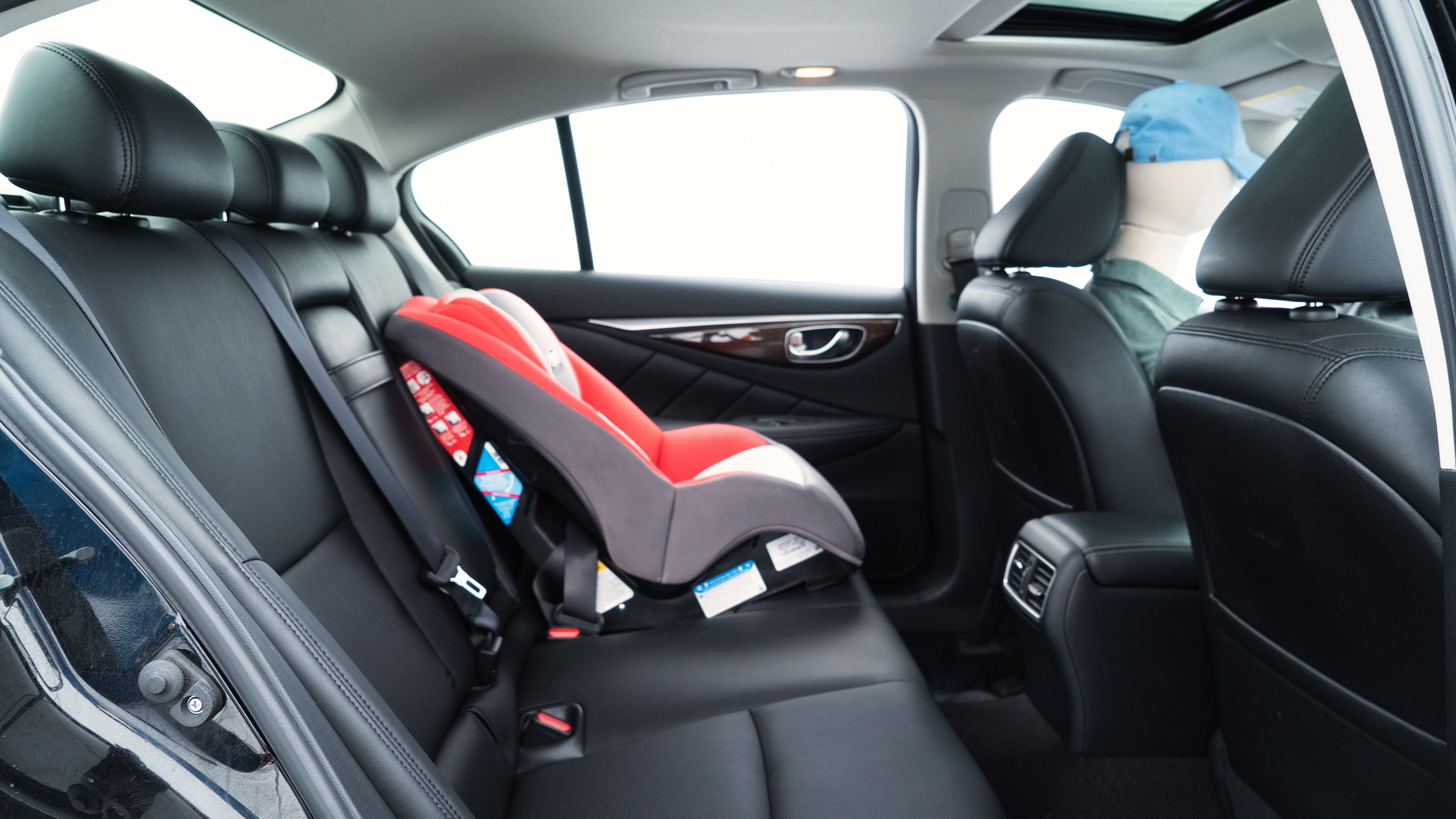 A series of second-row backseat photos is shown including one seating a baby seat and one seating a 6'1" mannequin.