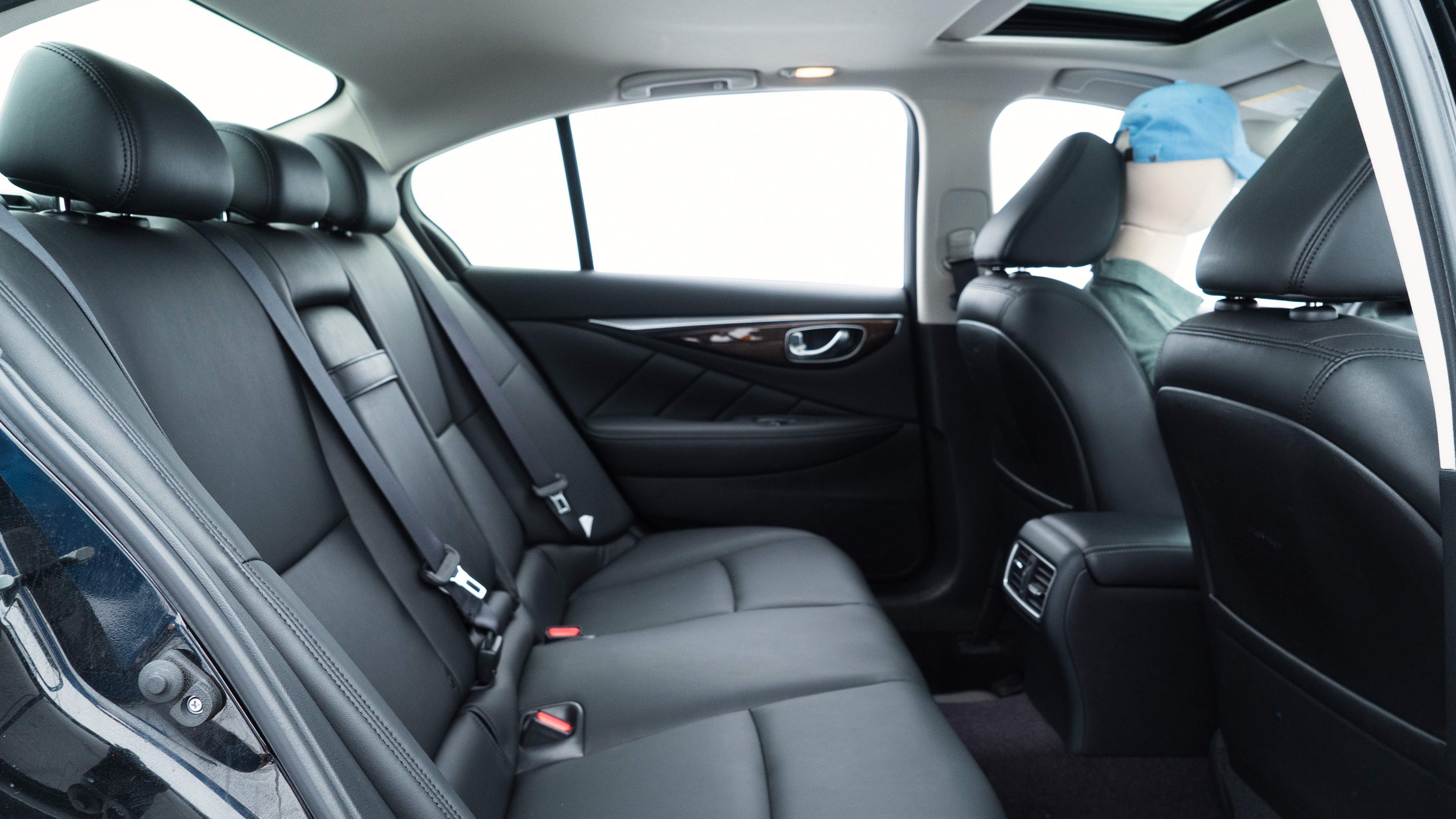 A series of second-row backseat photos is shown including one seating a baby seat and one seating a 6'1" mannequin.