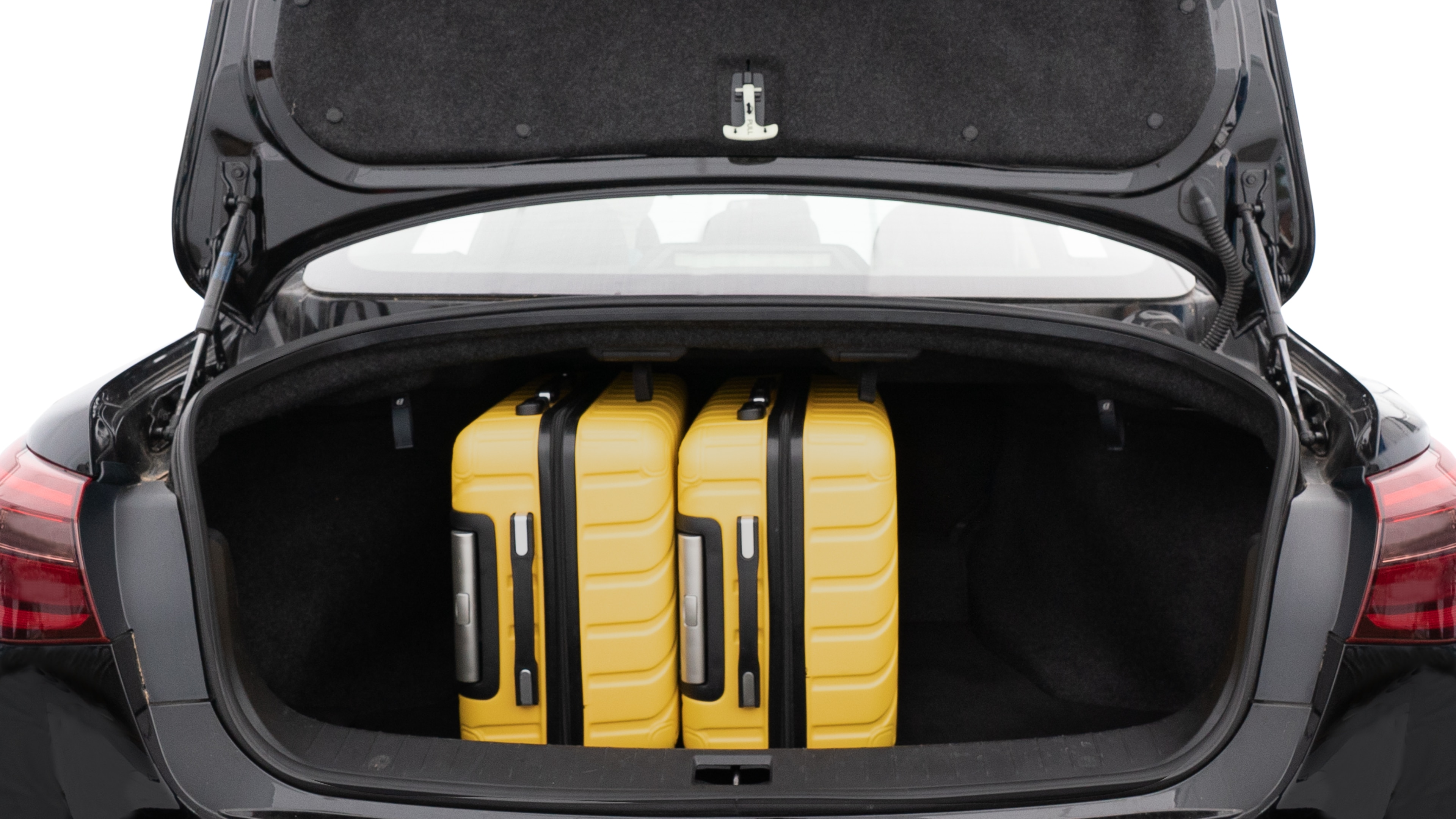 The trunk lid is open, showing full view of the trunk space. Two medium and one small suitcase are placed inside.