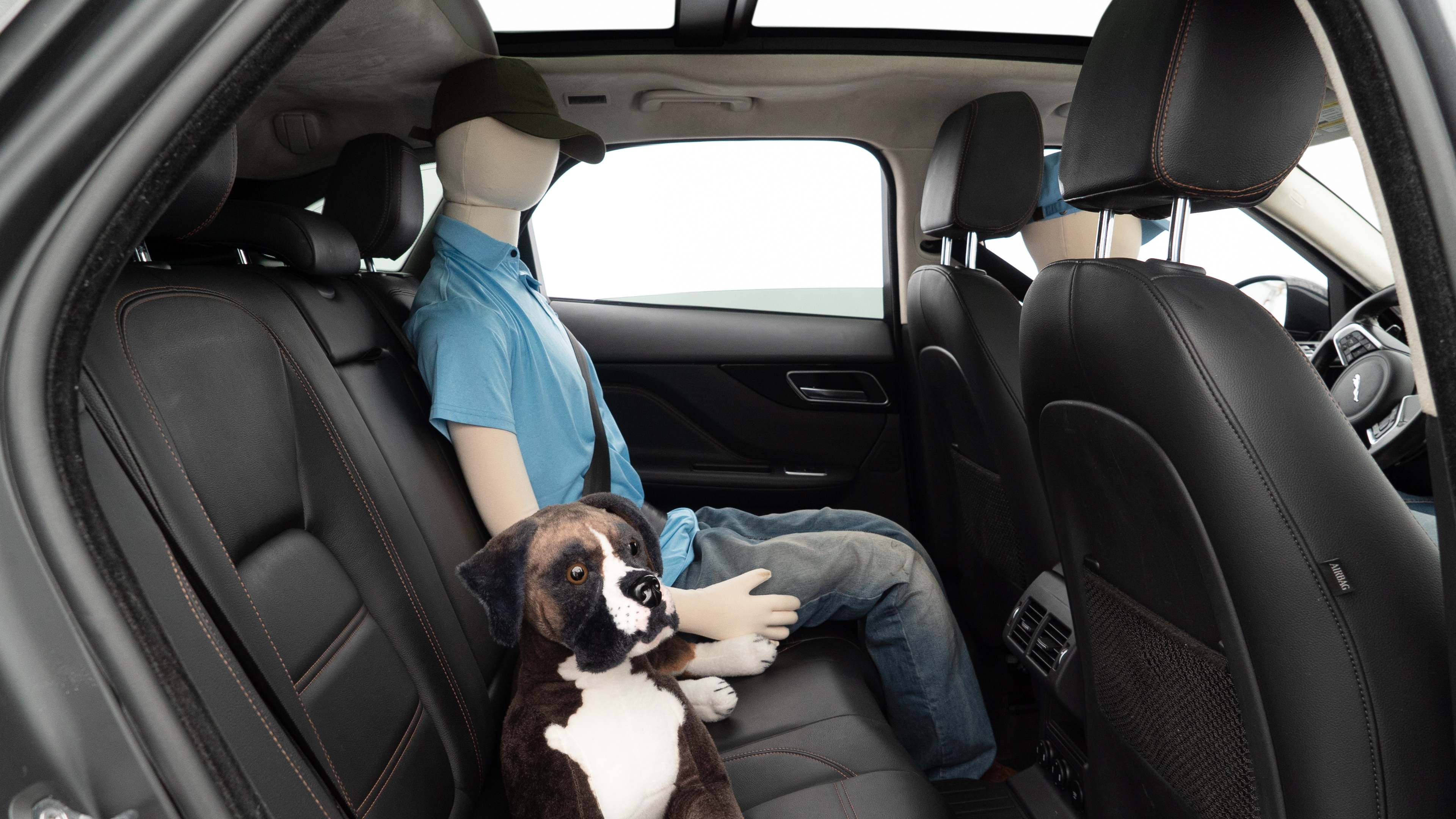 A series of second-row backseat photos is shown including one seating a baby seat and one seating a 6'1" mannequin.