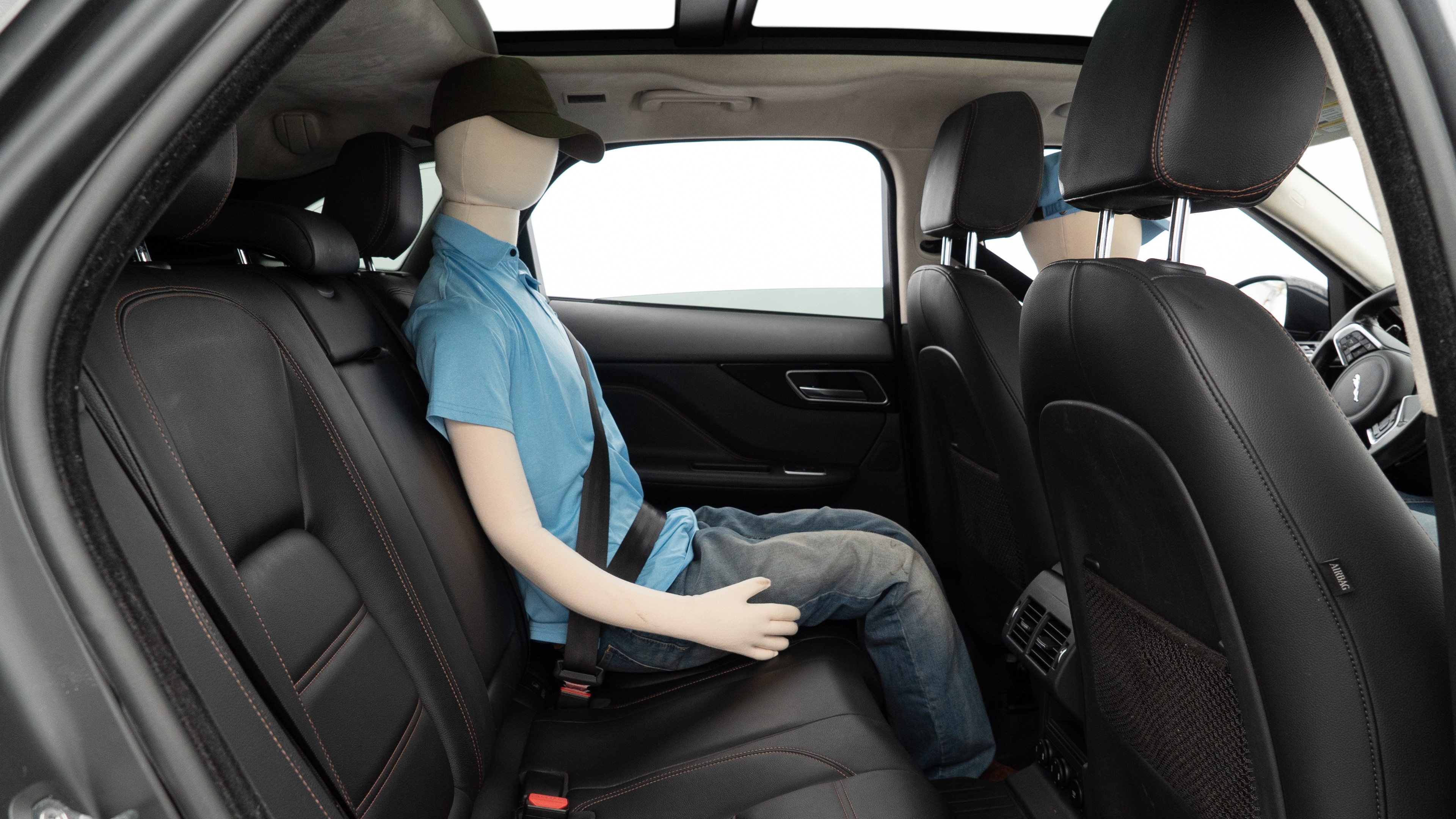 A series of second-row backseat photos is shown including one seating a baby seat and one seating a 6'1" mannequin.