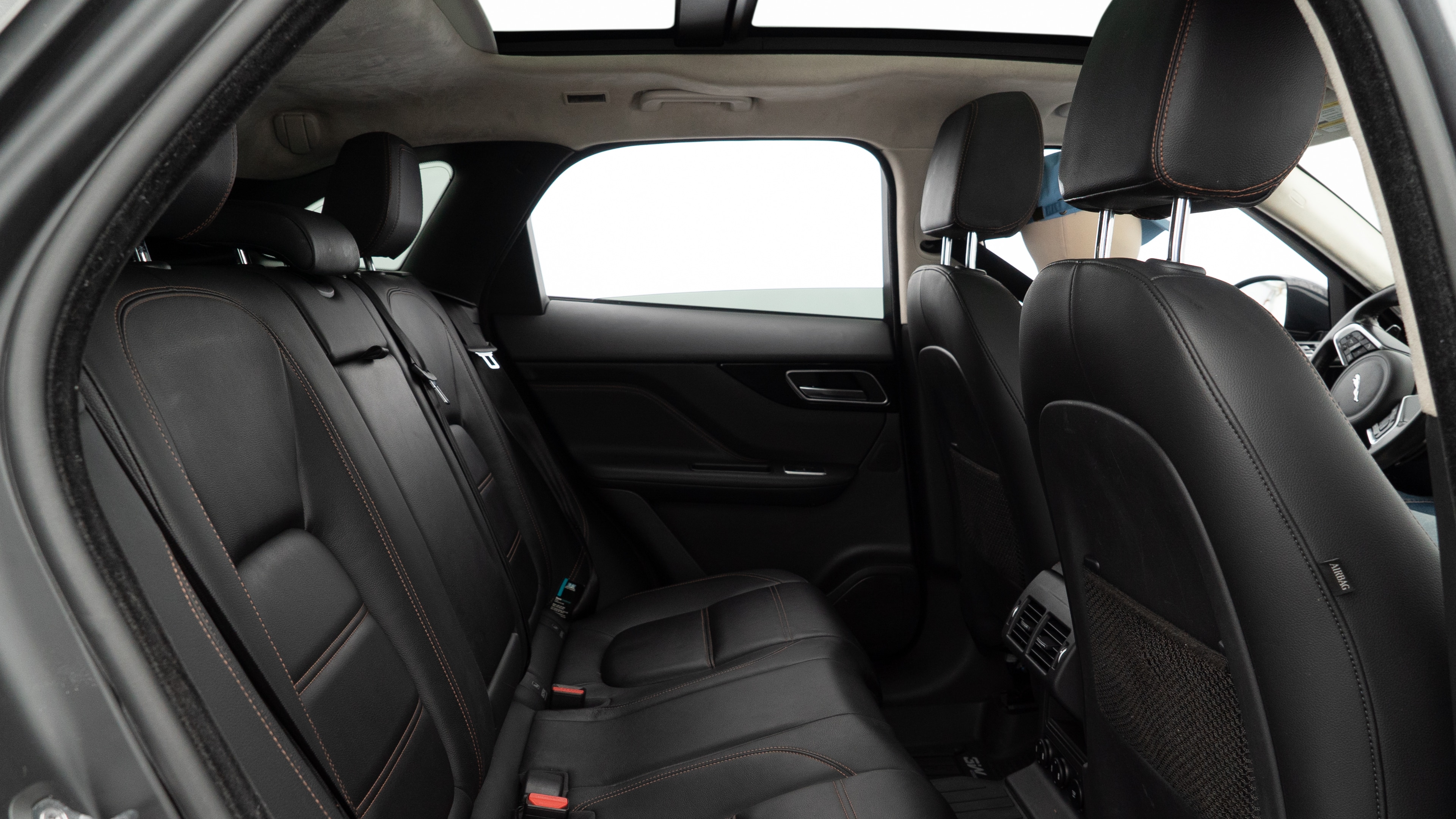 A series of second-row backseat photos is shown including one seating a baby seat and one seating a 6'1" mannequin.