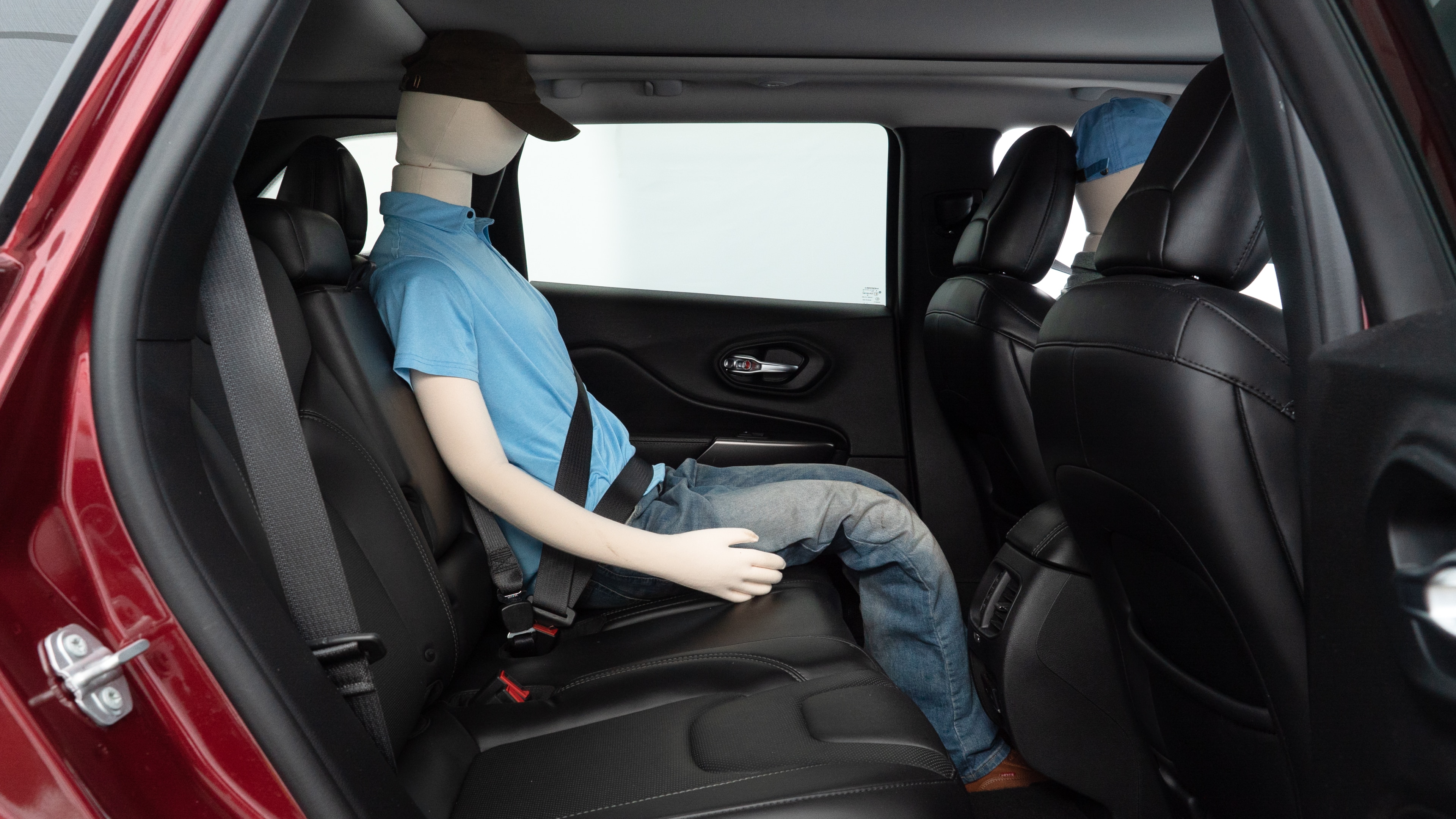 A series of second-row backseat photos is shown including one seating a baby seat and one seating a 6'1" mannequin.