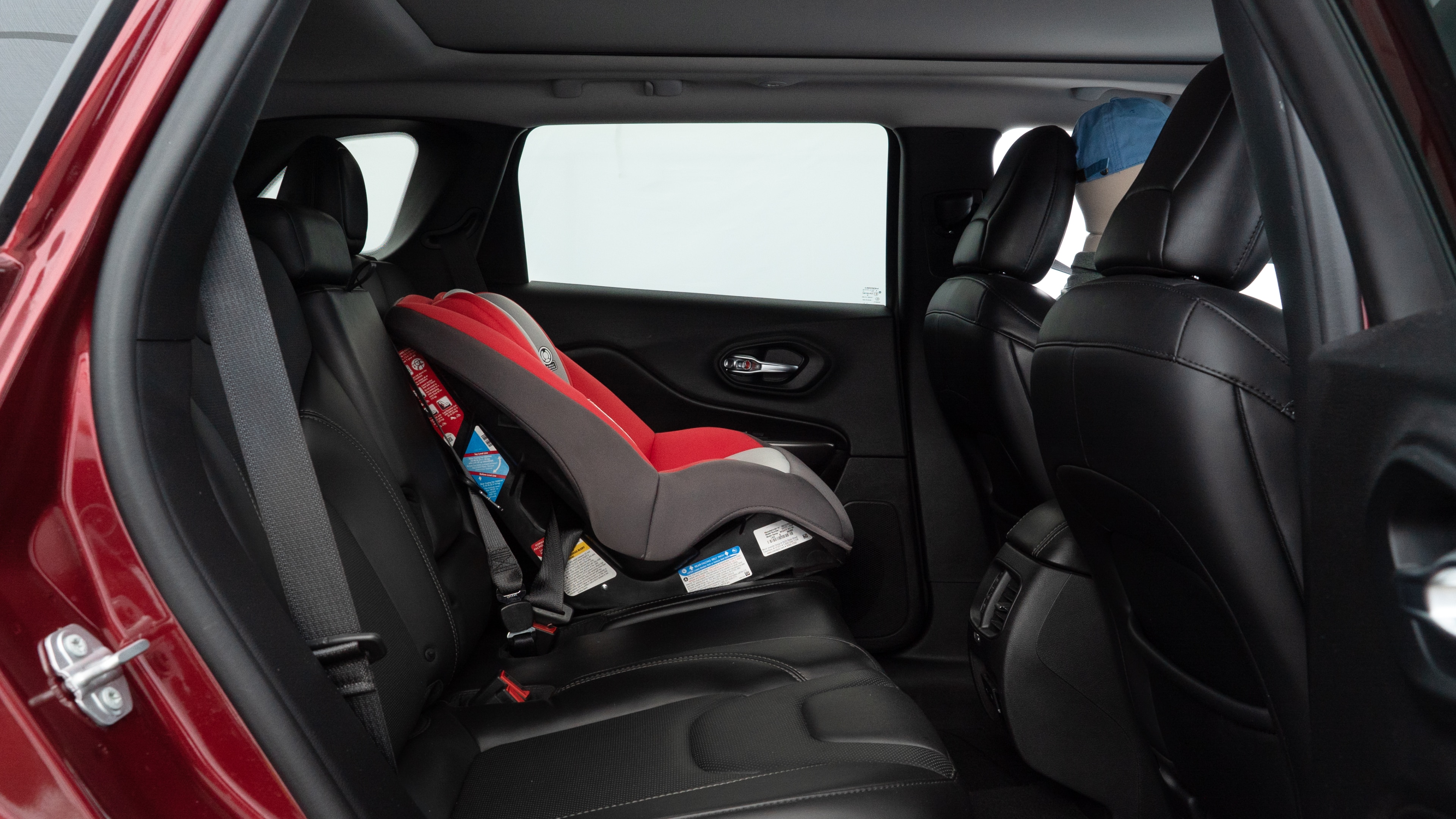 A series of second-row backseat photos is shown including one seating a baby seat and one seating a 6'1" mannequin.