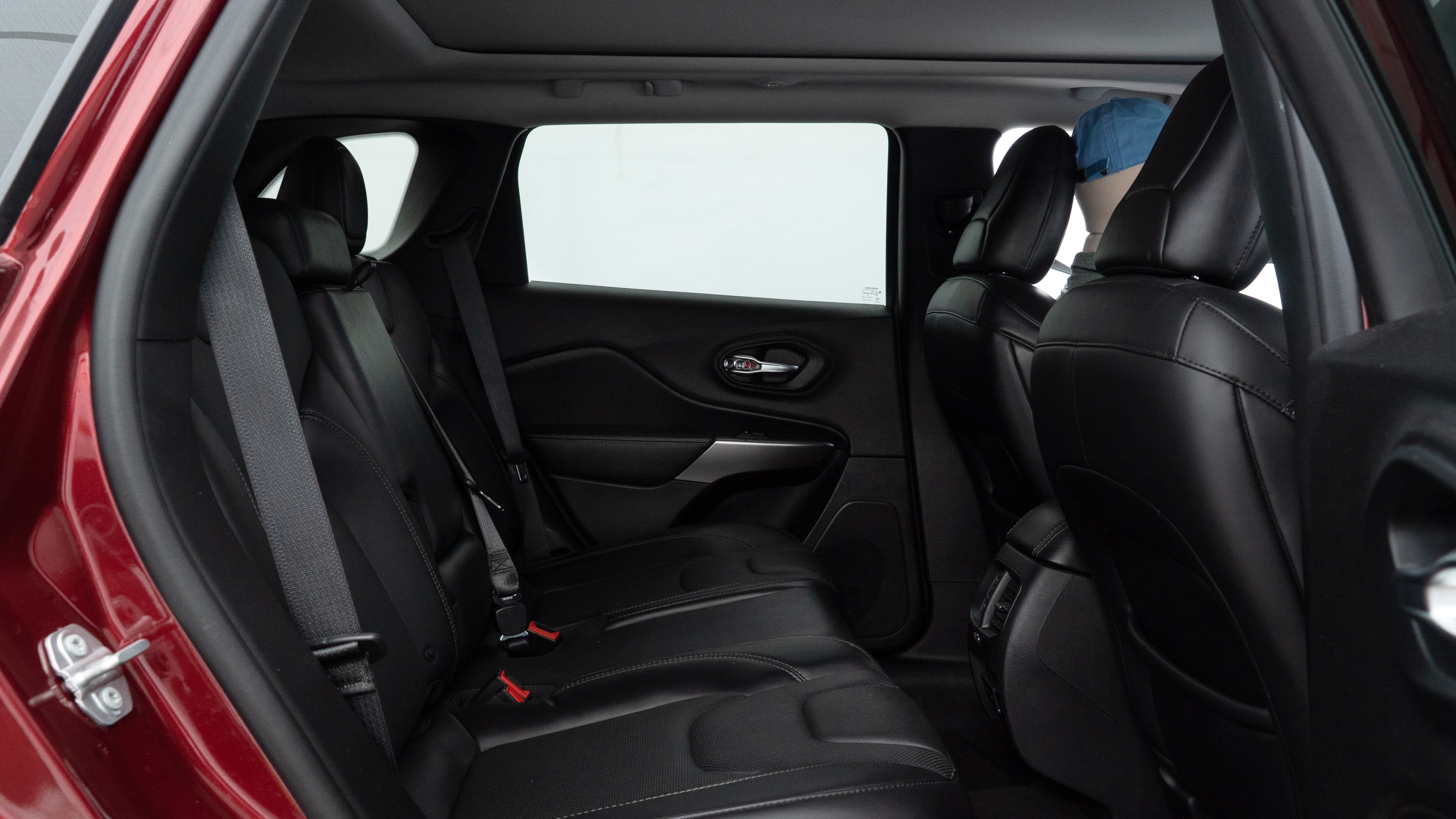 A series of second-row backseat photos is shown including one seating a baby seat and one seating a 6'1" mannequin.