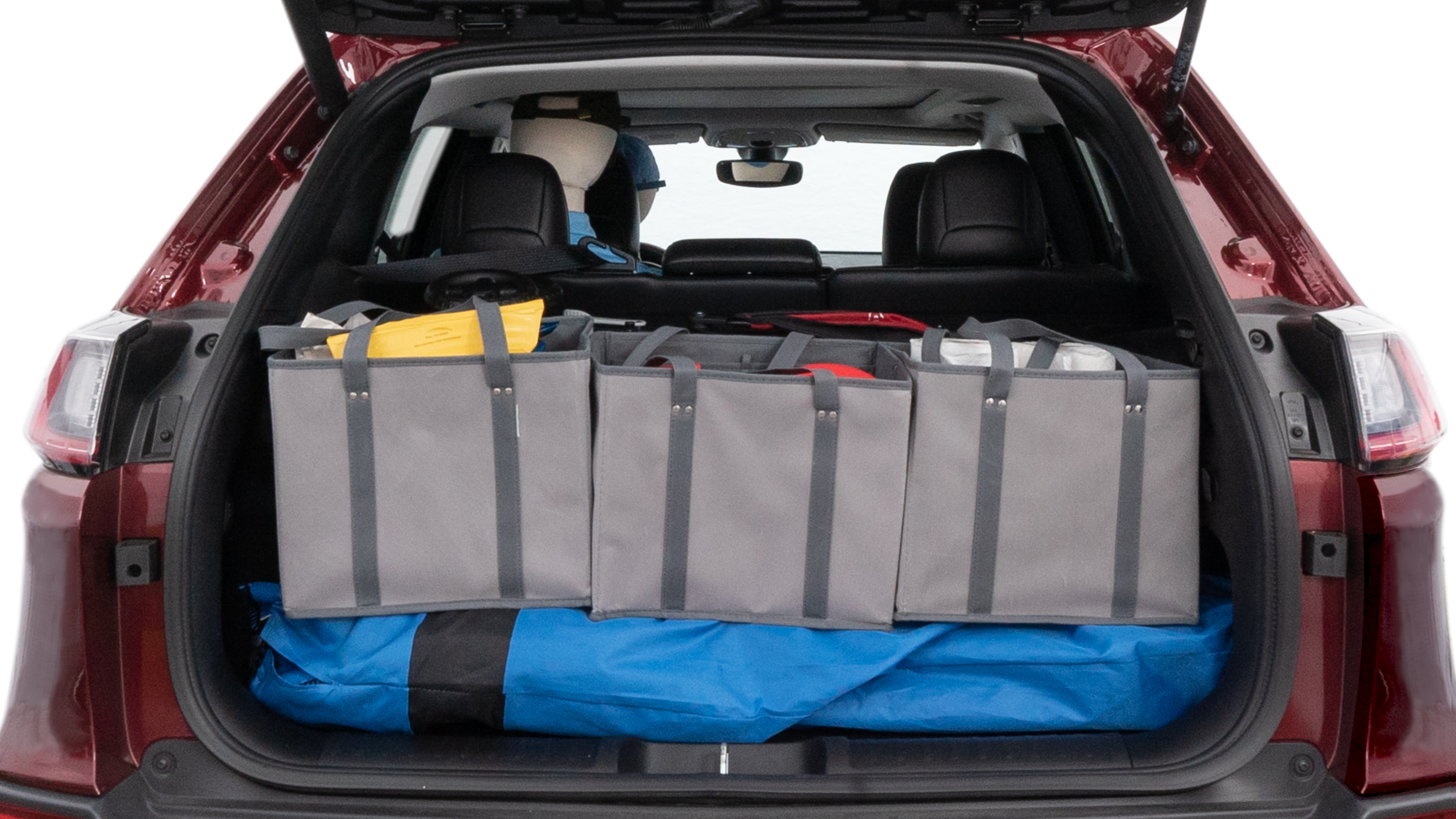 The cargo area is open giving a full view of the cargo area. A baby stroller, four grocery carriers, folded sports chair and a set of golf clubs are placed inside.