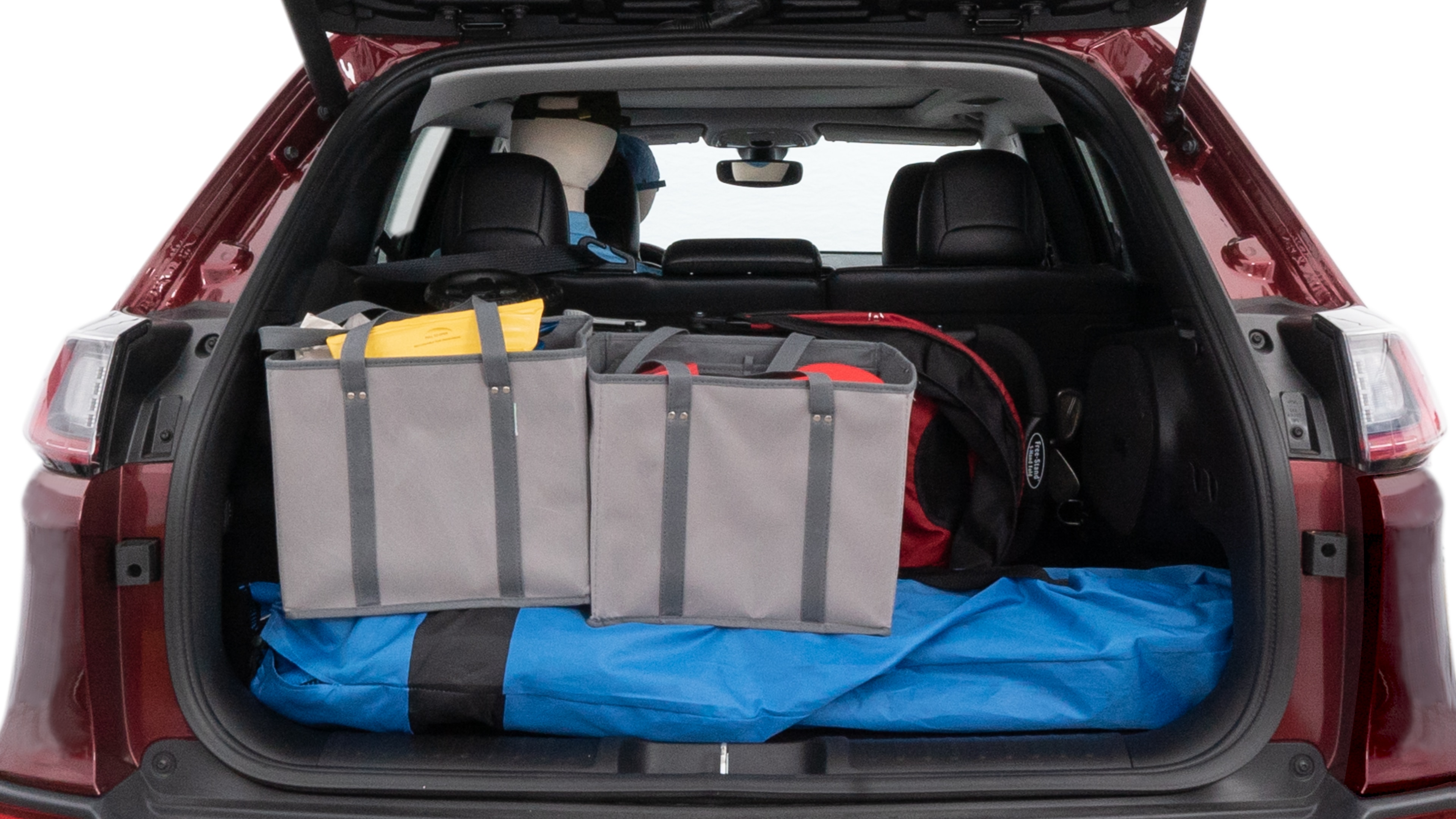 The cargo area is open giving a full view of the cargo area. A baby stroller, four grocery carriers, folded sports chair and a set of golf clubs are placed inside.