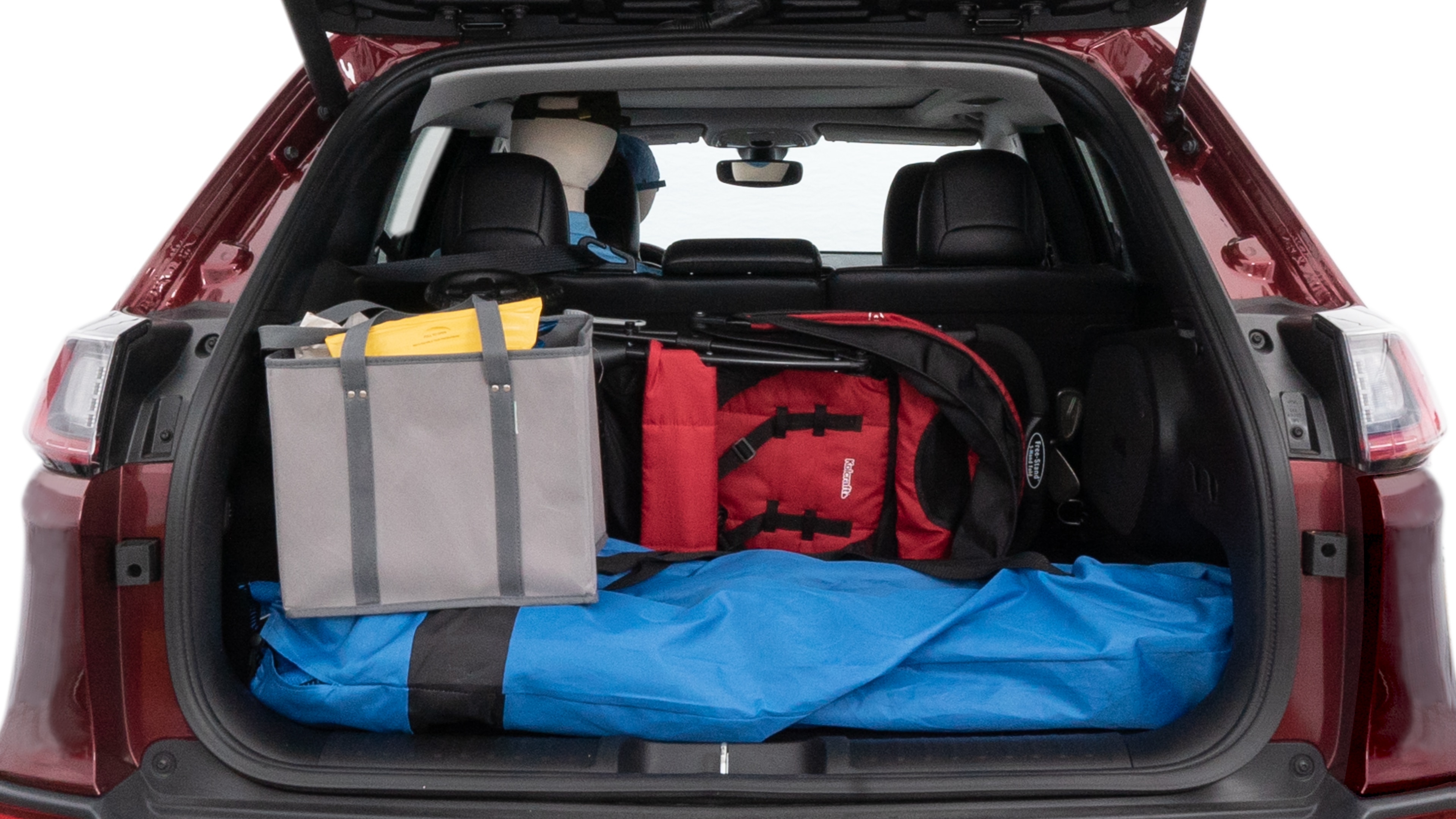 The cargo area is open giving a full view of the cargo area. A baby stroller, four grocery carriers, folded sports chair and a set of golf clubs are placed inside.
