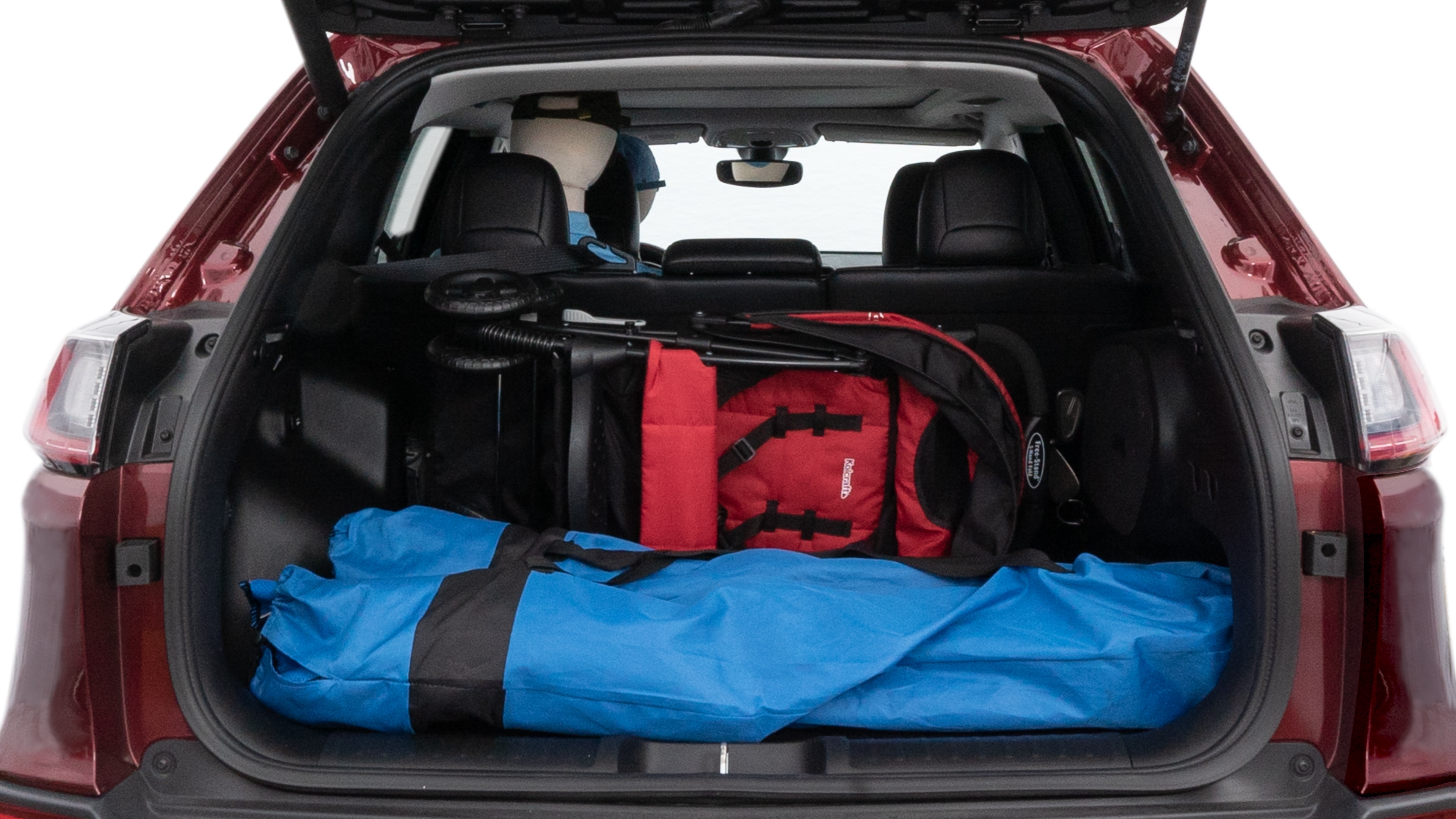 The cargo area is open giving a full view of the cargo area. A baby stroller, four grocery carriers, folded sports chair and a set of golf clubs are placed inside.