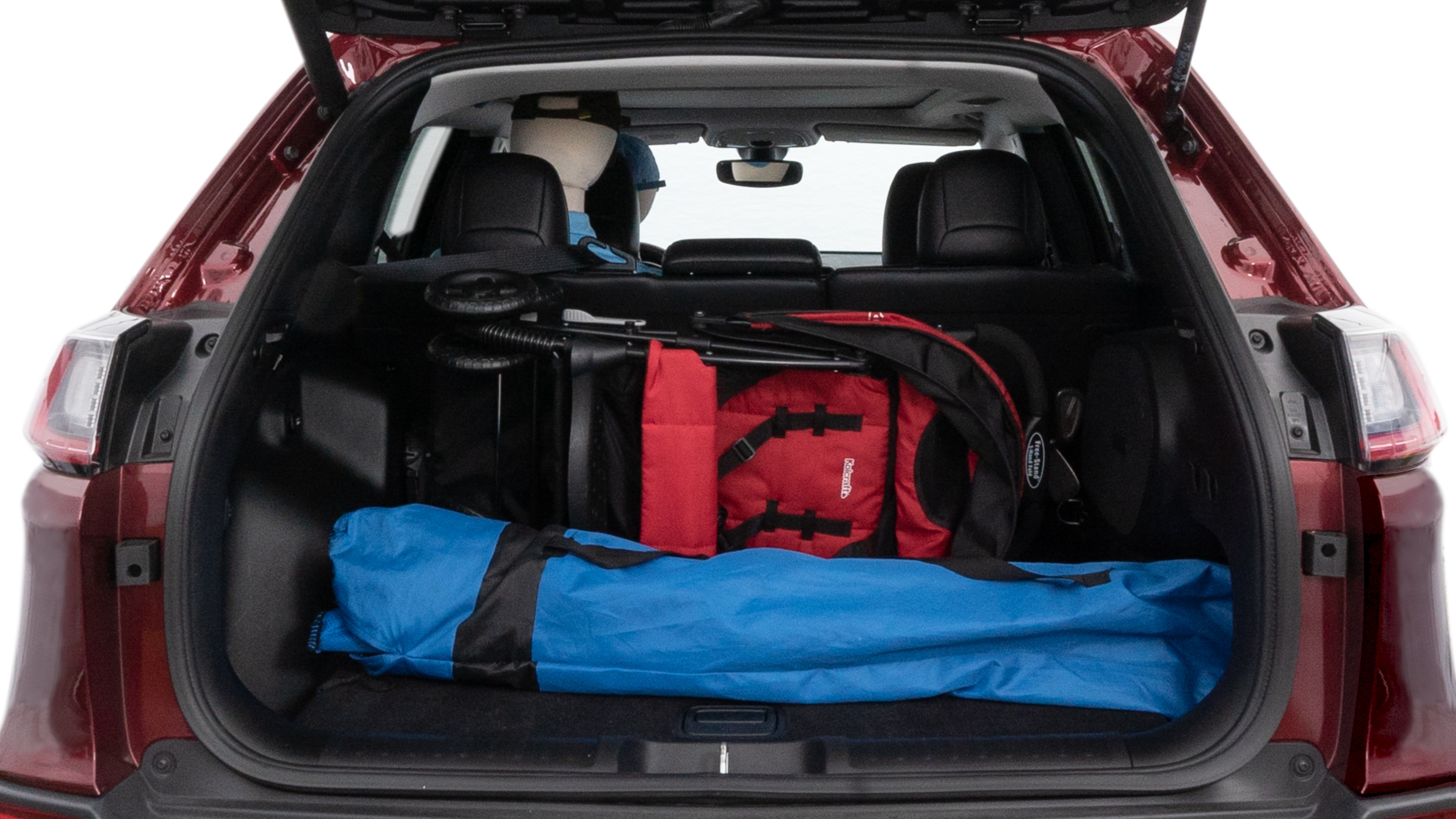 The cargo area is open giving a full view of the cargo area. A baby stroller, four grocery carriers, folded sports chair and a set of golf clubs are placed inside.