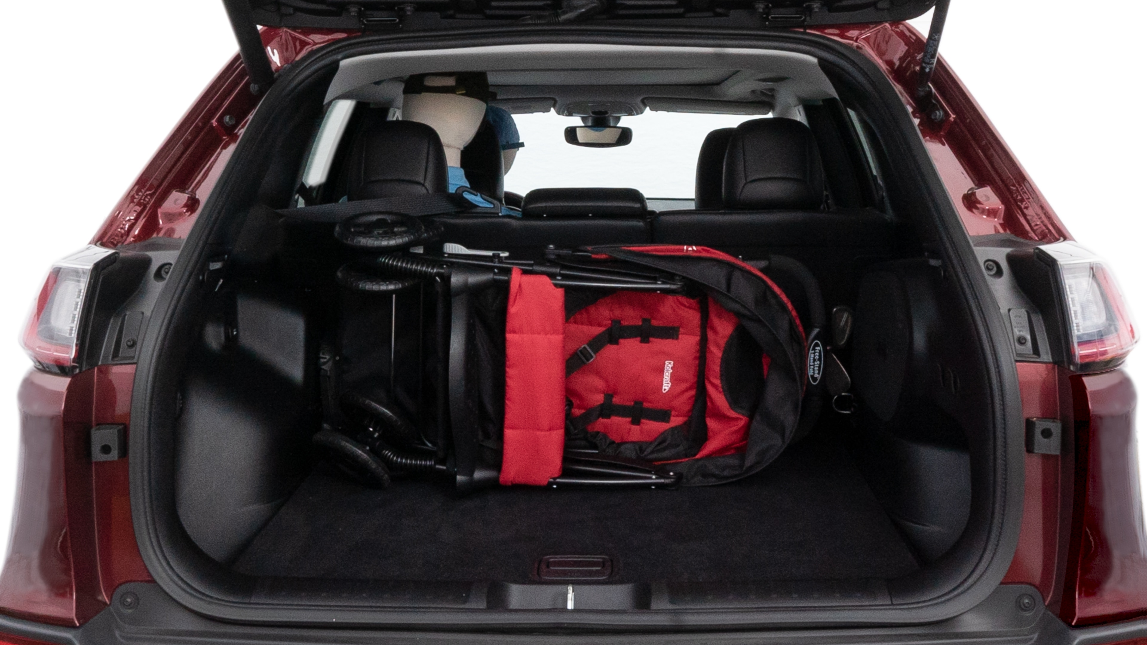 The cargo area is open giving a full view of the cargo area. A baby stroller, four grocery carriers, folded sports chair and a set of golf clubs are placed inside.