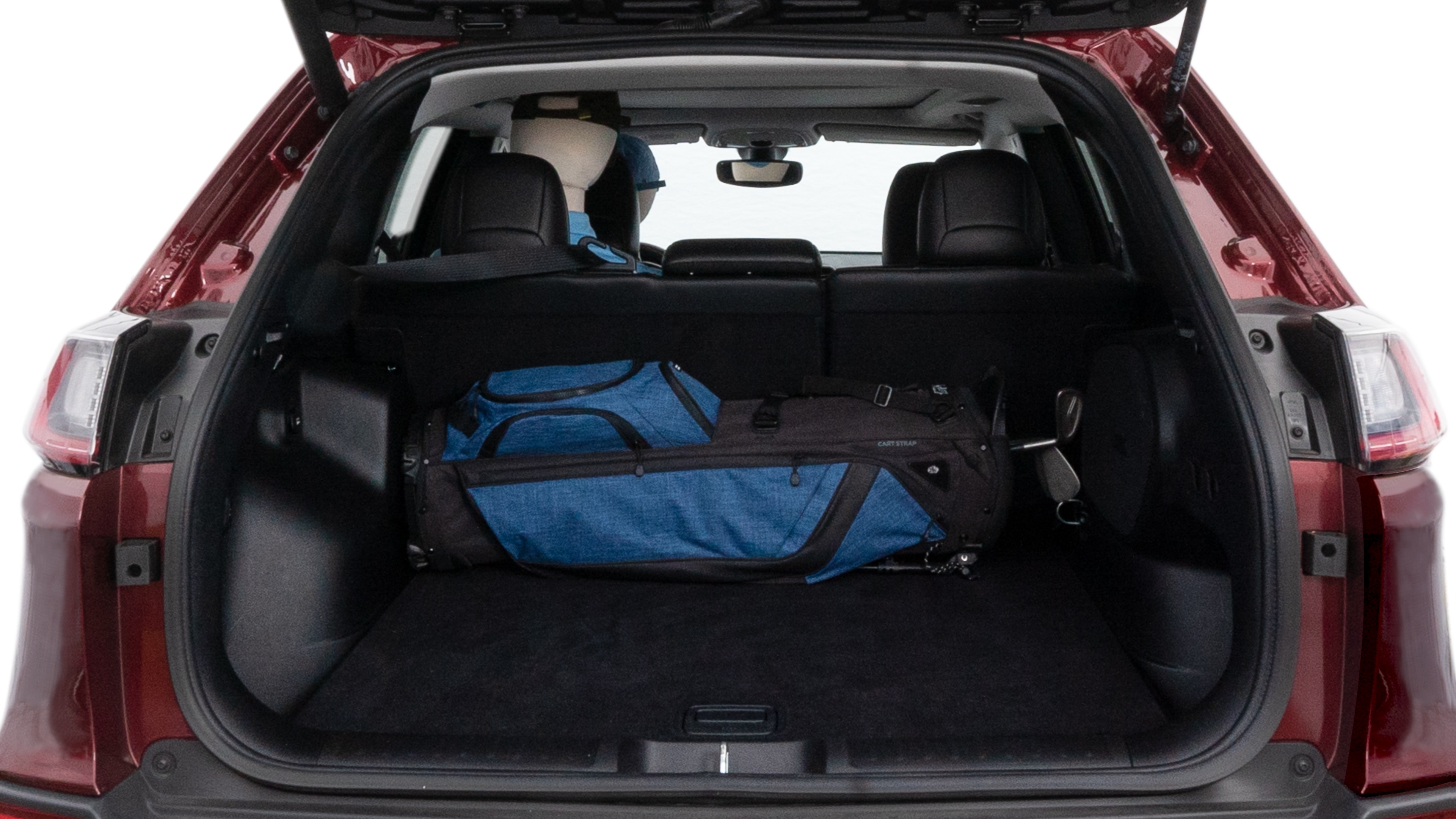 The cargo area is open giving a full view of the cargo area. A baby stroller, four grocery carriers, folded sports chair and a set of golf clubs are placed inside.