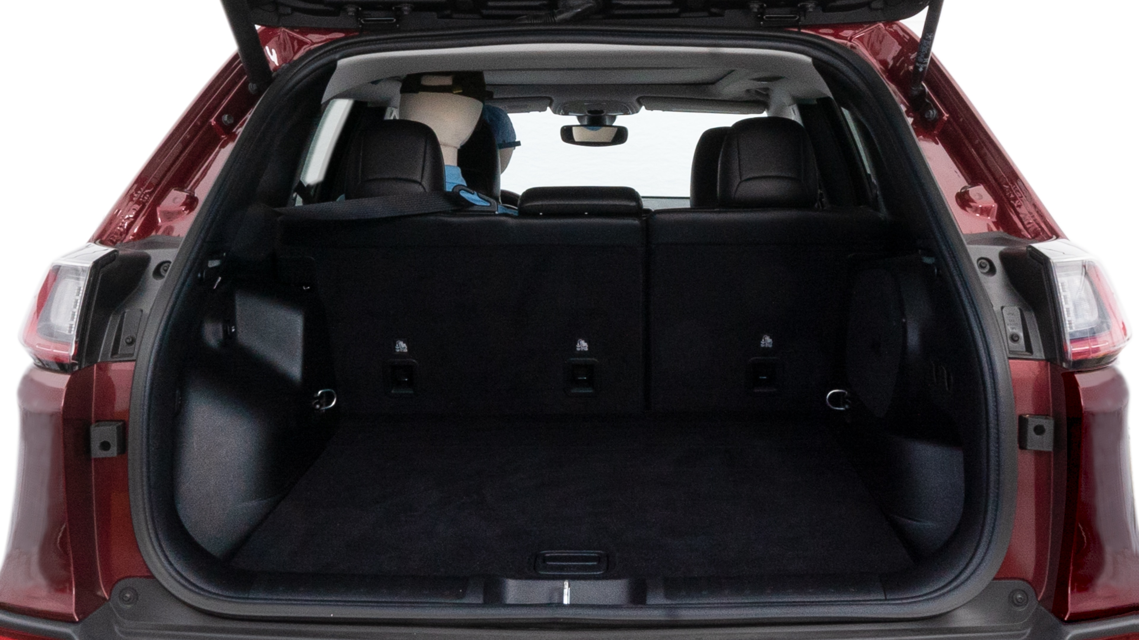 The cargo area is open giving a full view of the cargo area. A baby stroller, four grocery carriers, folded sports chair and a set of golf clubs are placed inside.