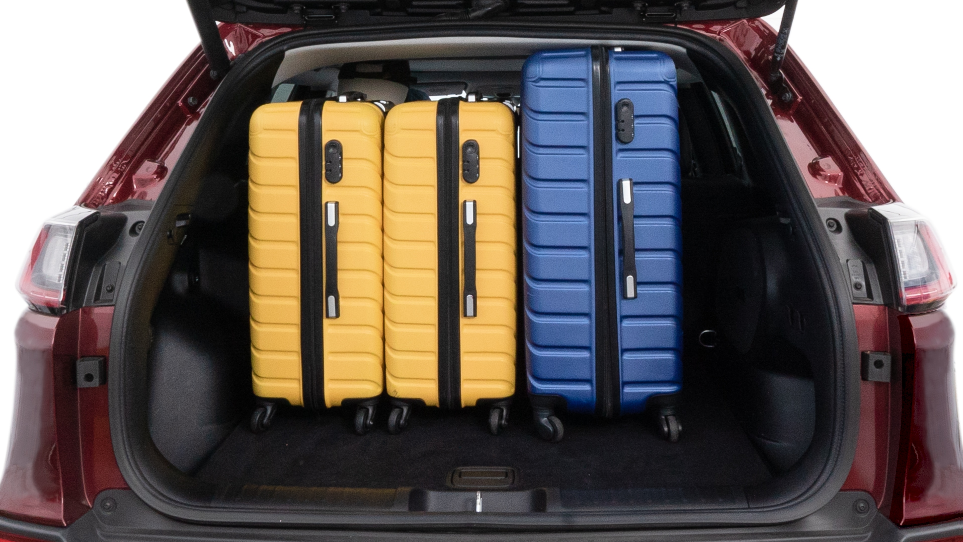 The trunk lid is open, showing full view of the trunk space. One large, two medium and two small suitcases are placed inside.