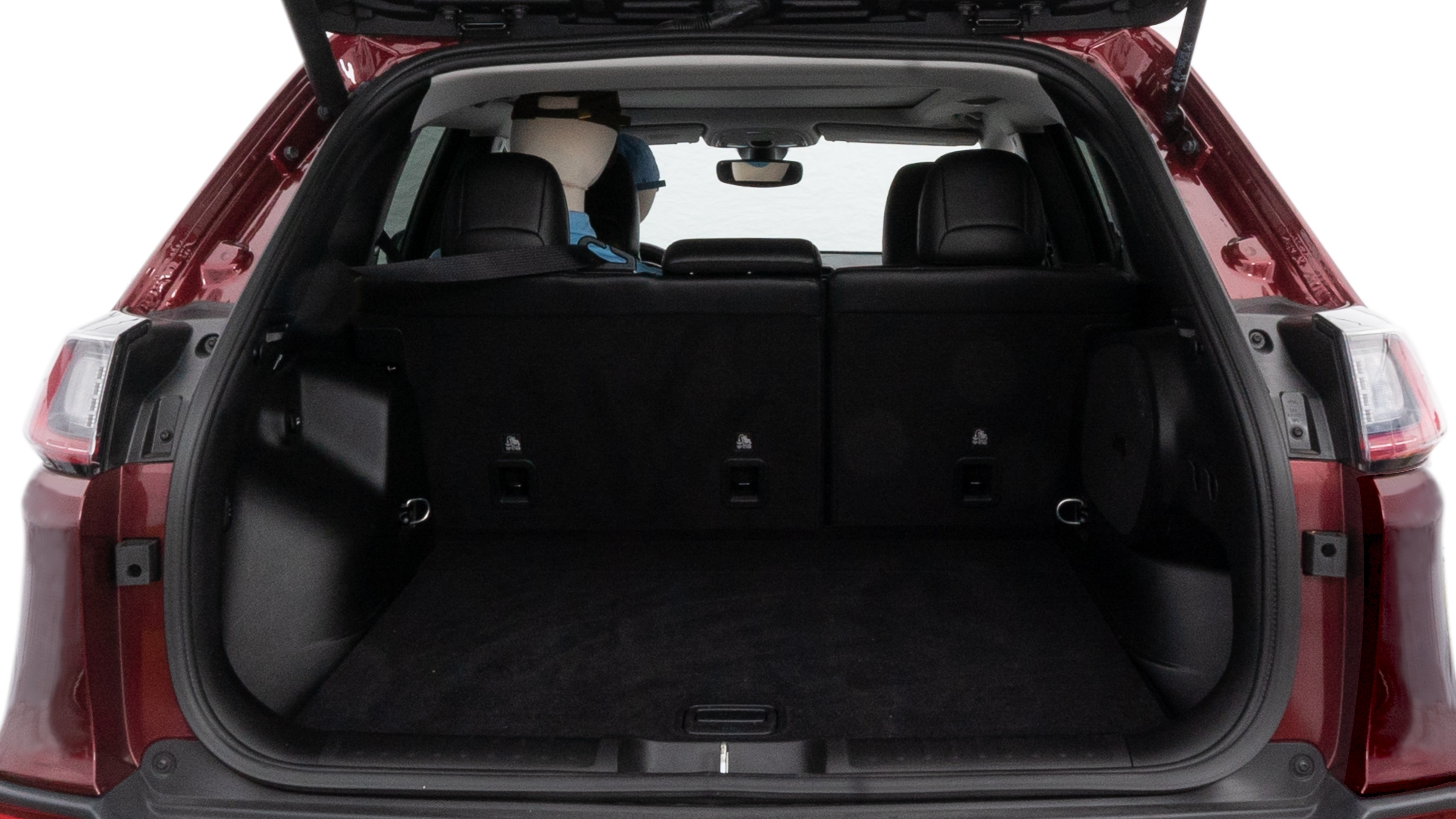 The trunk lid is open, showing full view of the trunk space. One large, two medium and two small suitcases are placed inside.